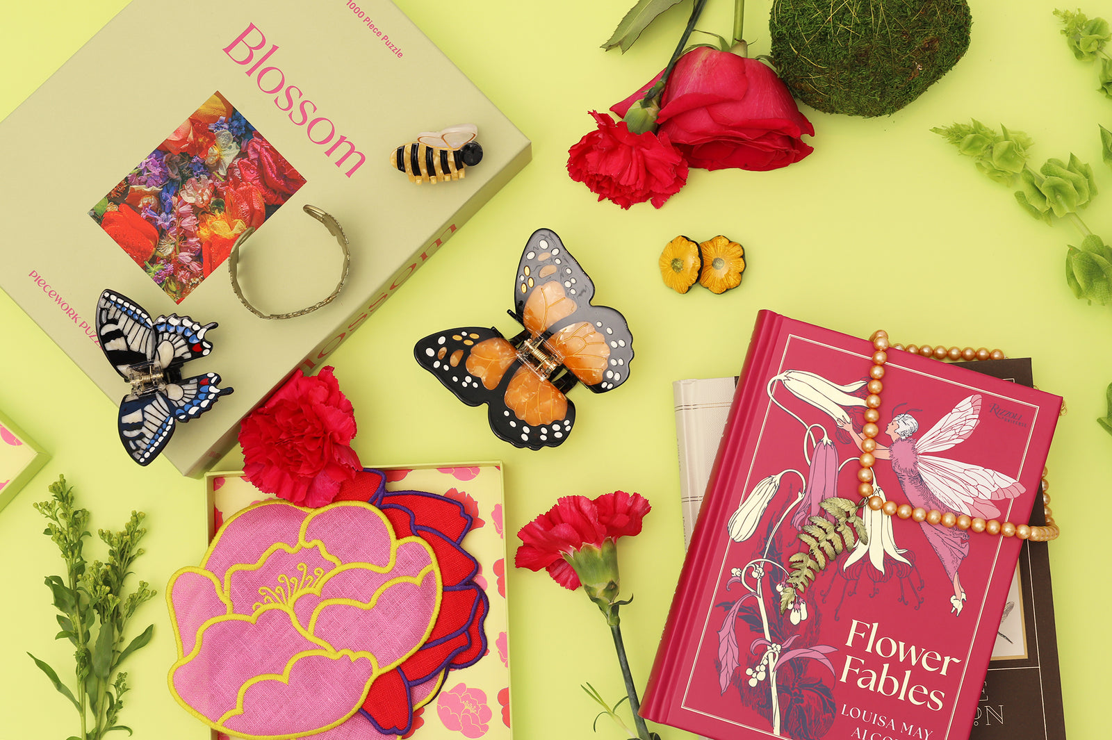 Decorative items including books, flowers, and jewelry on a yellow background