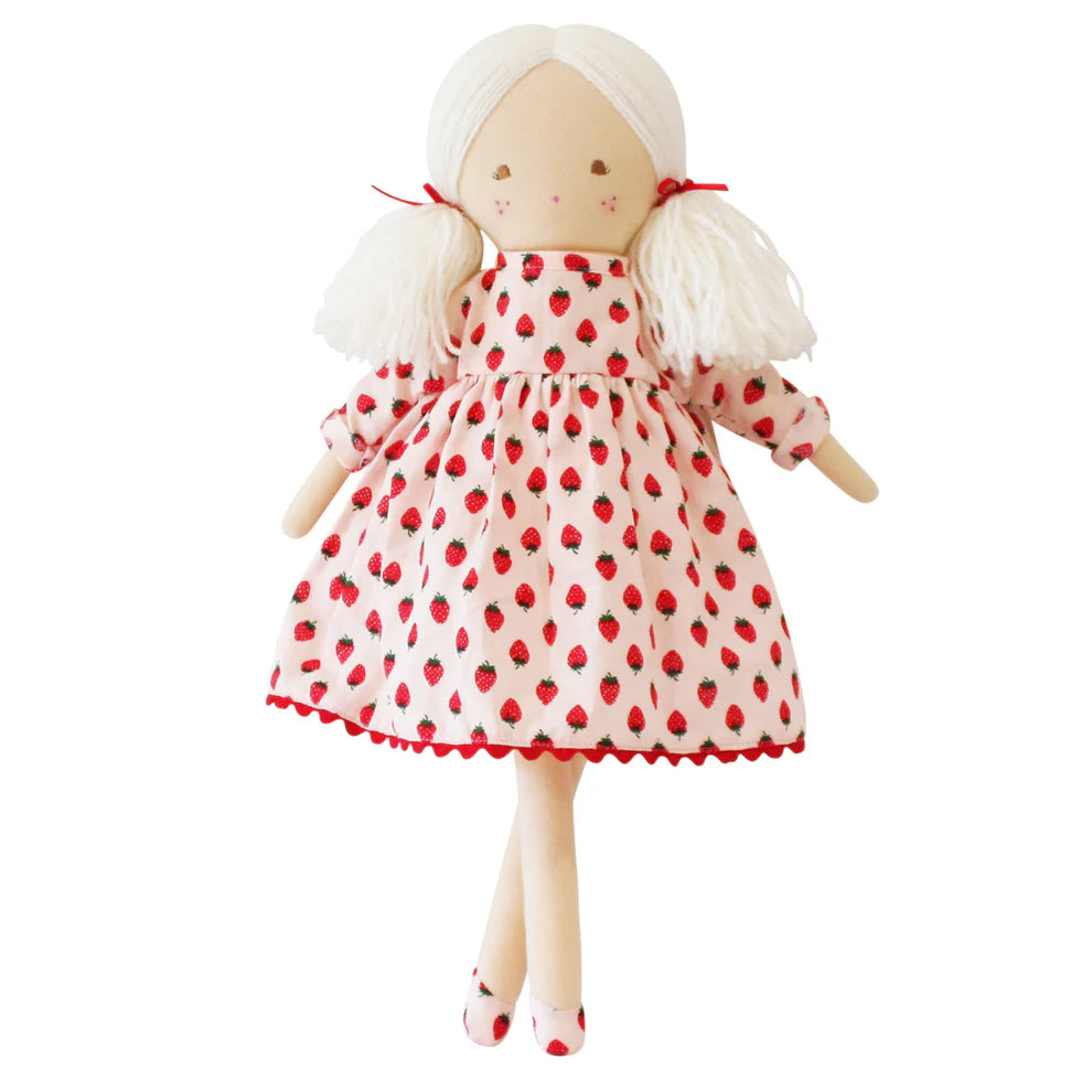 Doll wearing a red and white dress with strawberry pattern on a white background