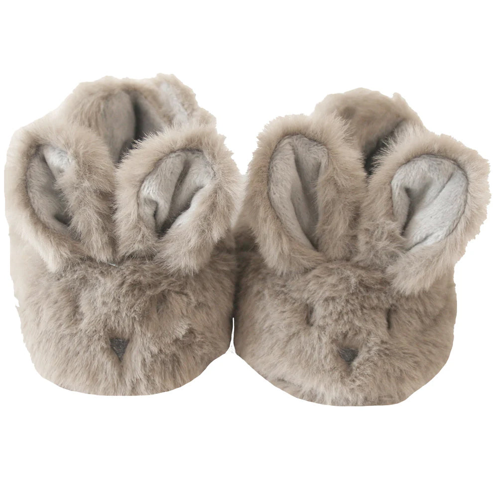 Pair of fluffy slippers with bunny ears on a white background