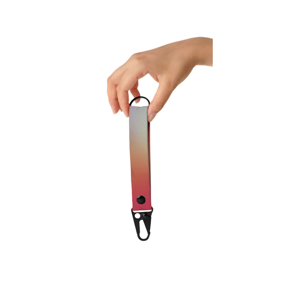 Gradient keychain with a hand holding it on a white background
