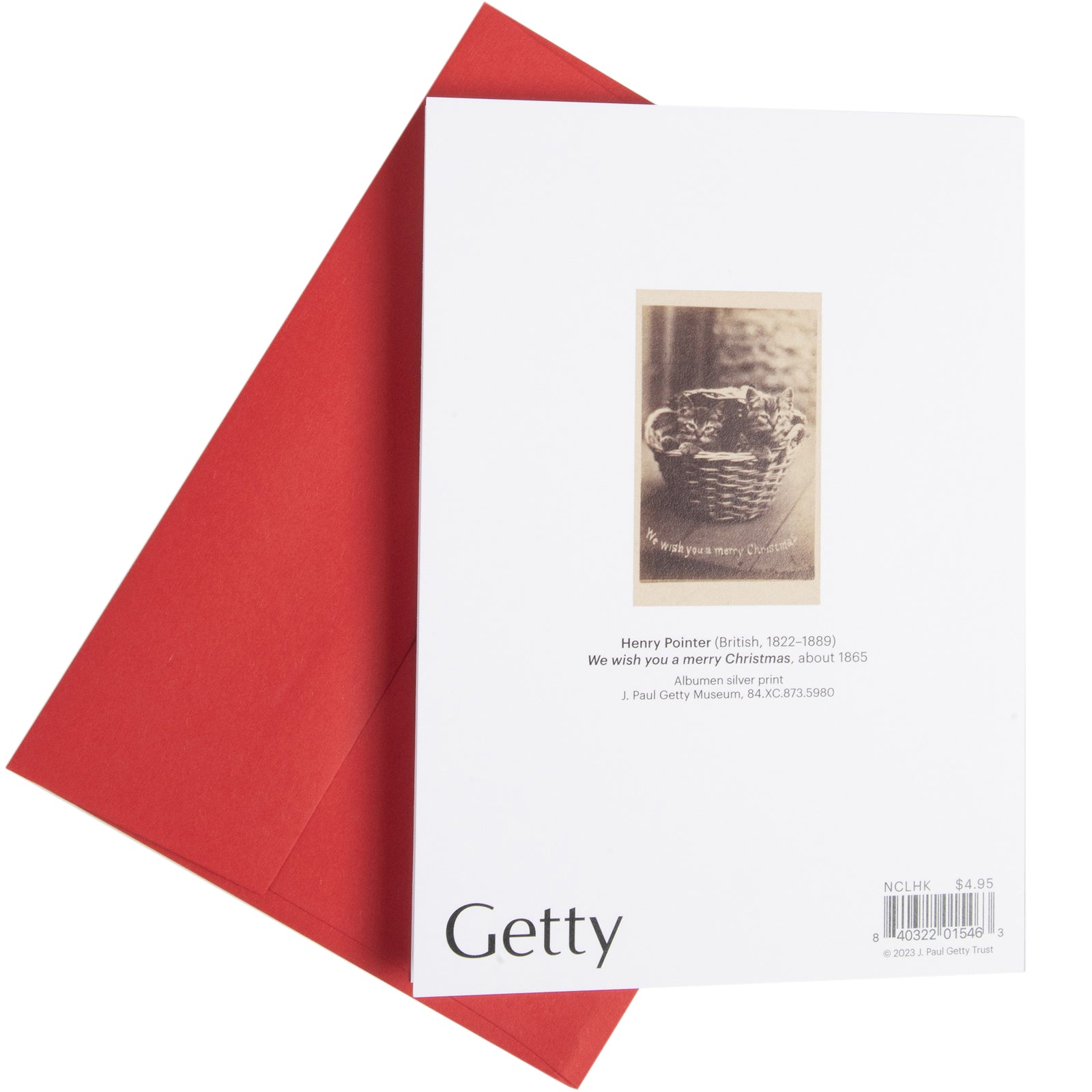 A holiday card featuring a historical photograph of two kittens in a basket with a 'We wish you a merry Christmas' caption, accompanied by a red envelope.