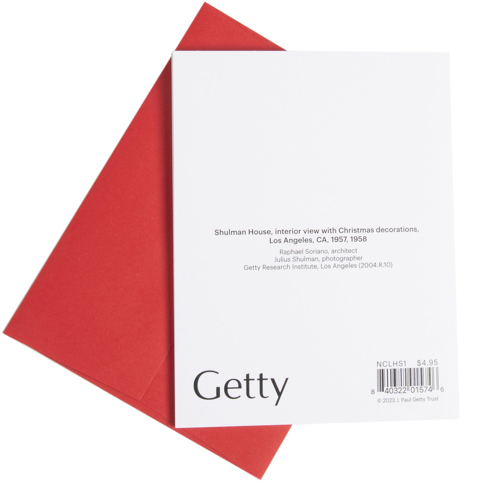 A holiday greeting card featuring a photograph of a Christmas tree, presents, and a red and white coffee set, with a red envelope.