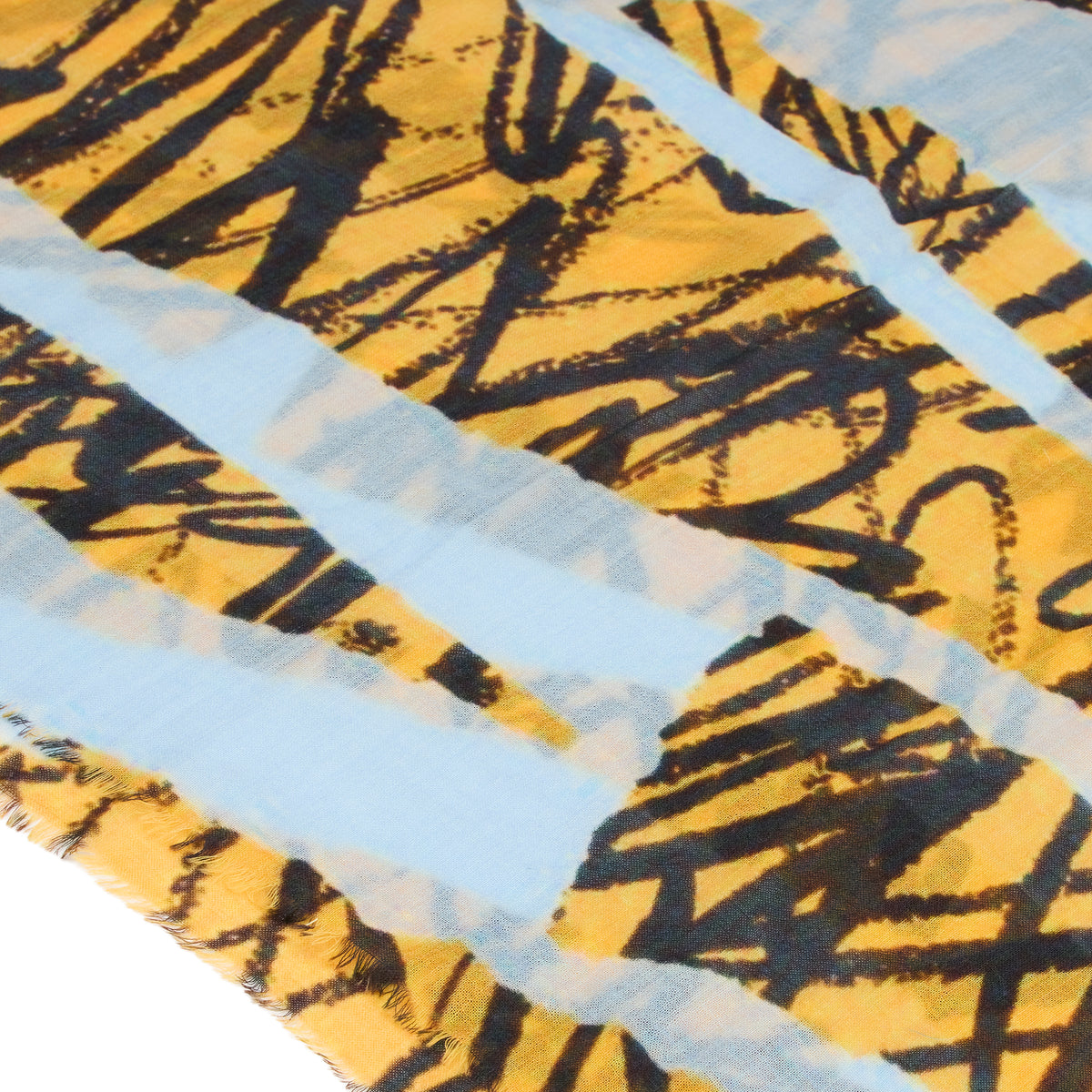 Close-up of a patterned fabric with black abstract designs on a yellow background