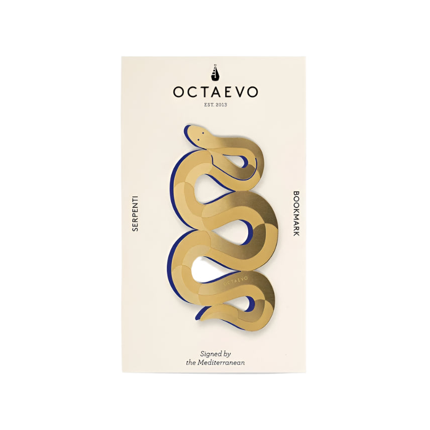 A brass bookmark designed in the shape of a coiled snake, presented on a card
