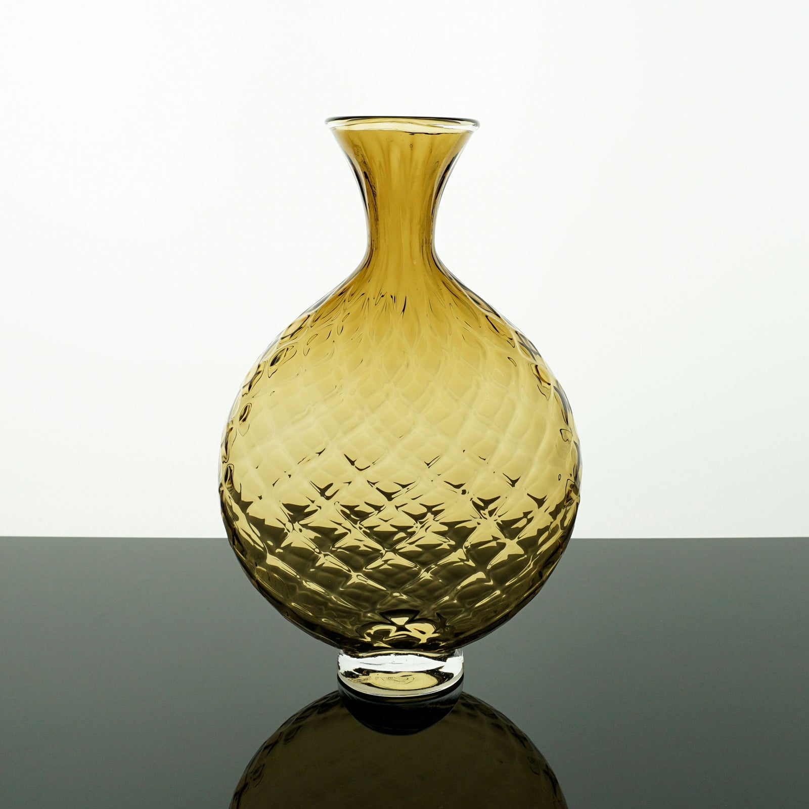 Amber colored textured vase on a white background