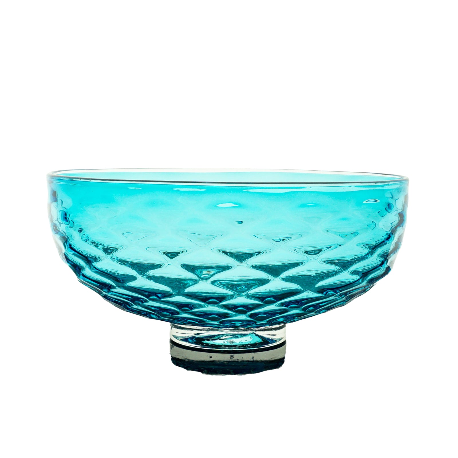 Turquoise glass bowl with textured design on a white background