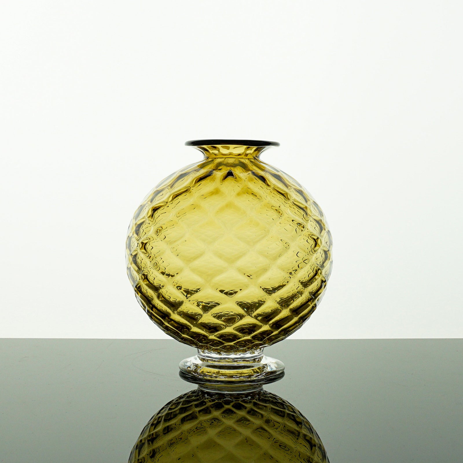 Yellow green textured glass vase on a white background