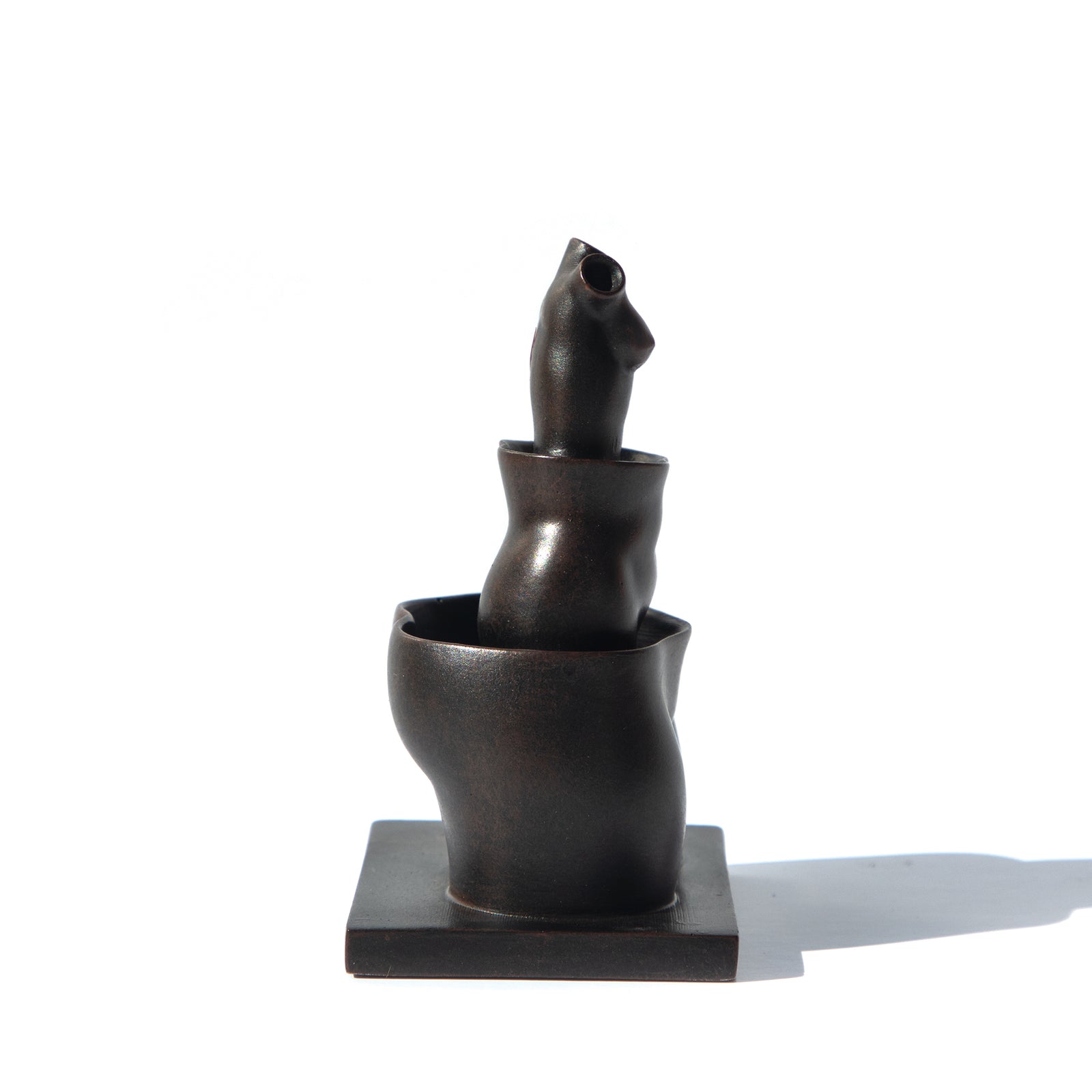 A miniature sculpture reproduction of René Magritte's La Folie Des Grandeurs featuring three hollow female forms stacked within each other.