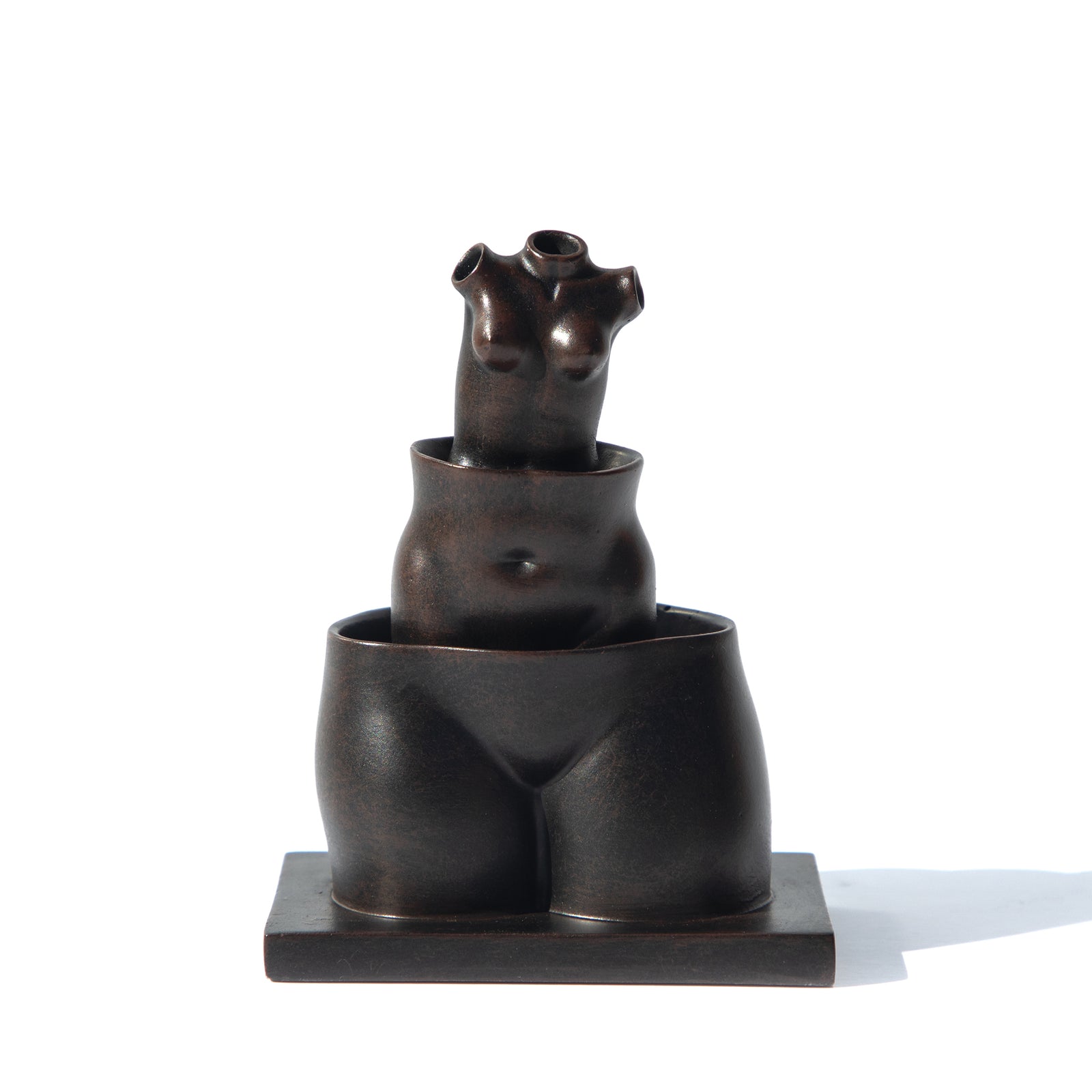 A miniature sculpture reproduction of René Magritte's La Folie Des Grandeurs featuring three hollow female forms stacked within each other.