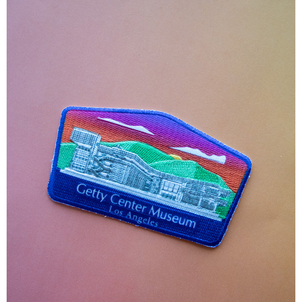 A patch depicting the Getty Center Museum in Los Angeles with a multicolored background and blue border.