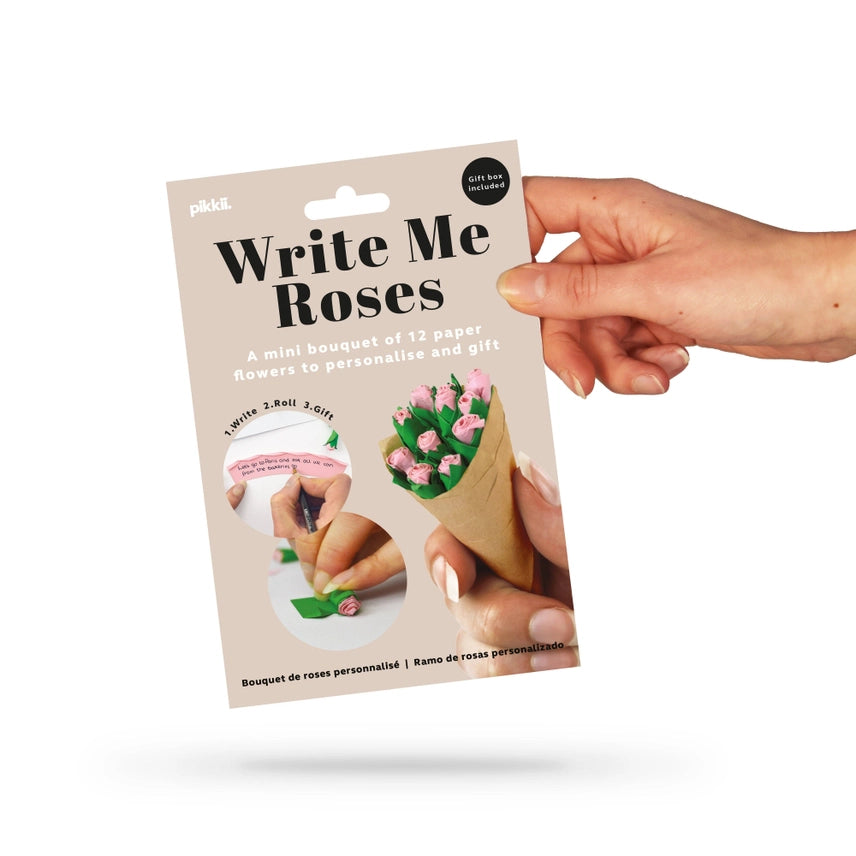 Hand holding a 'Write Me Roses' product packaging on a white background