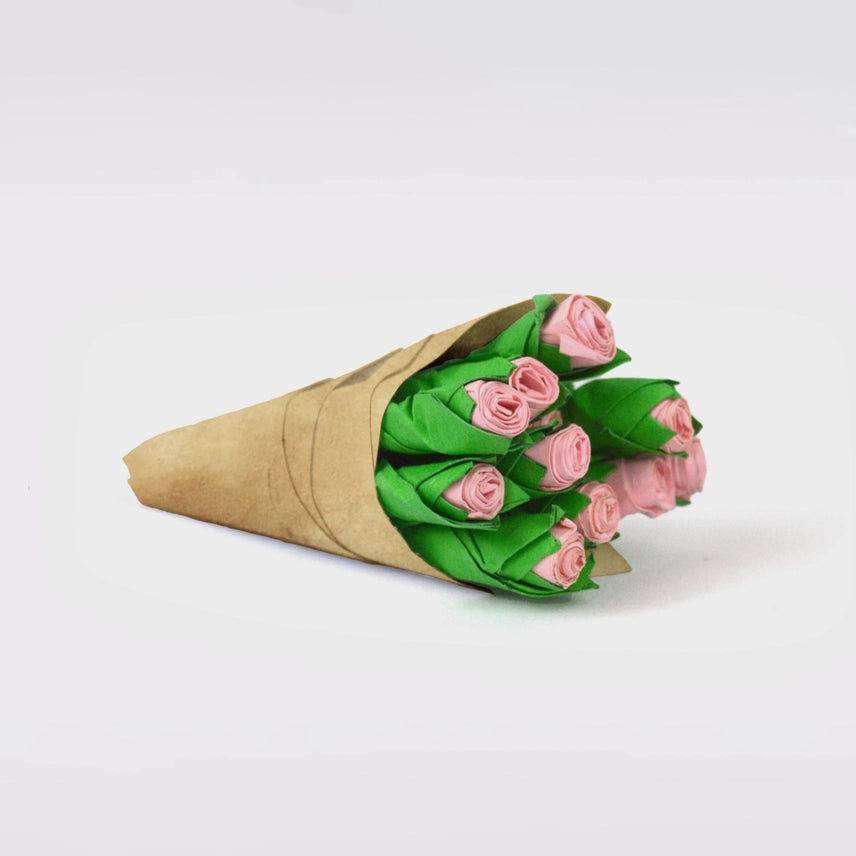 Hand holding a 'Write Me Roses' product packaging on a white background