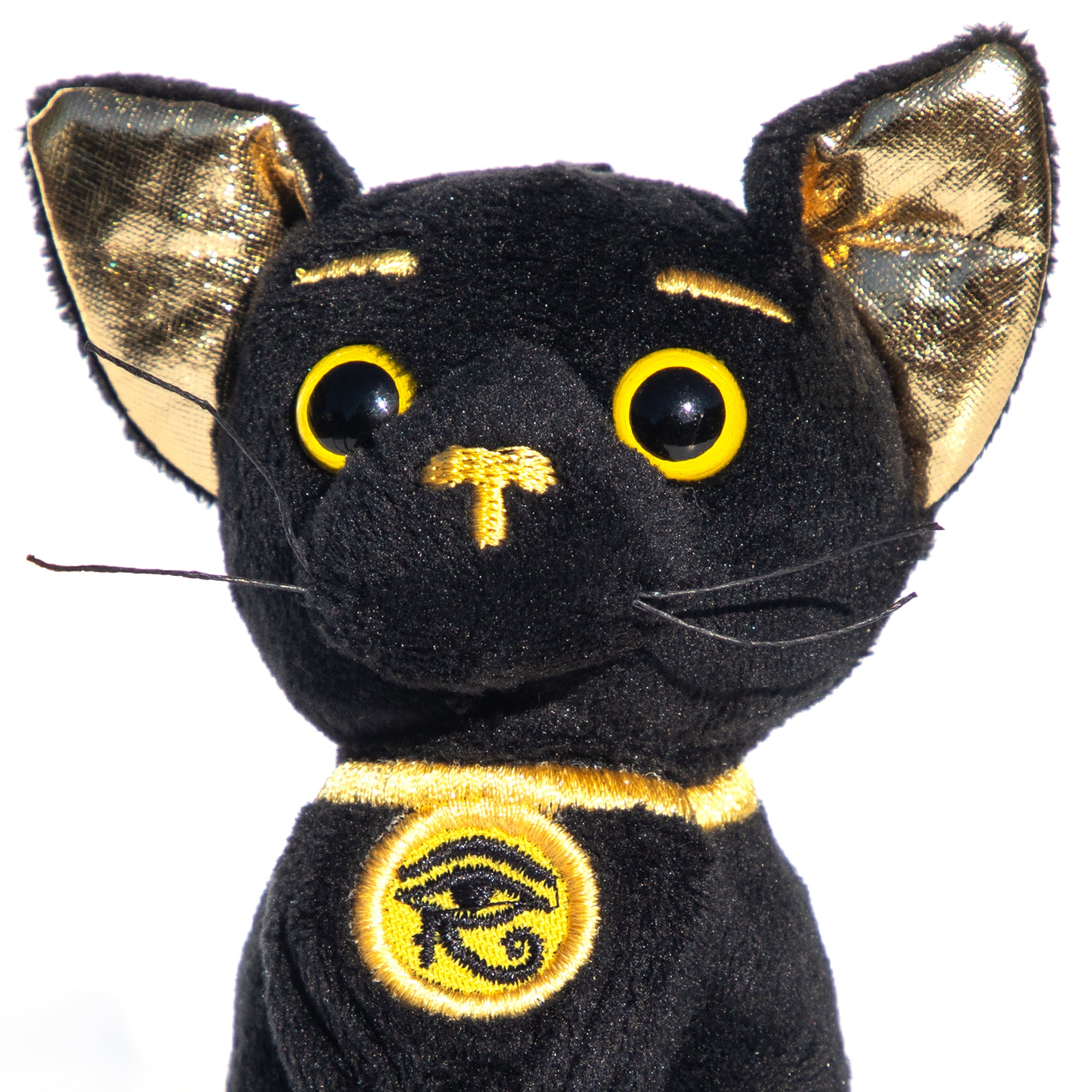 Black cat plush toy with gold accents on a white background