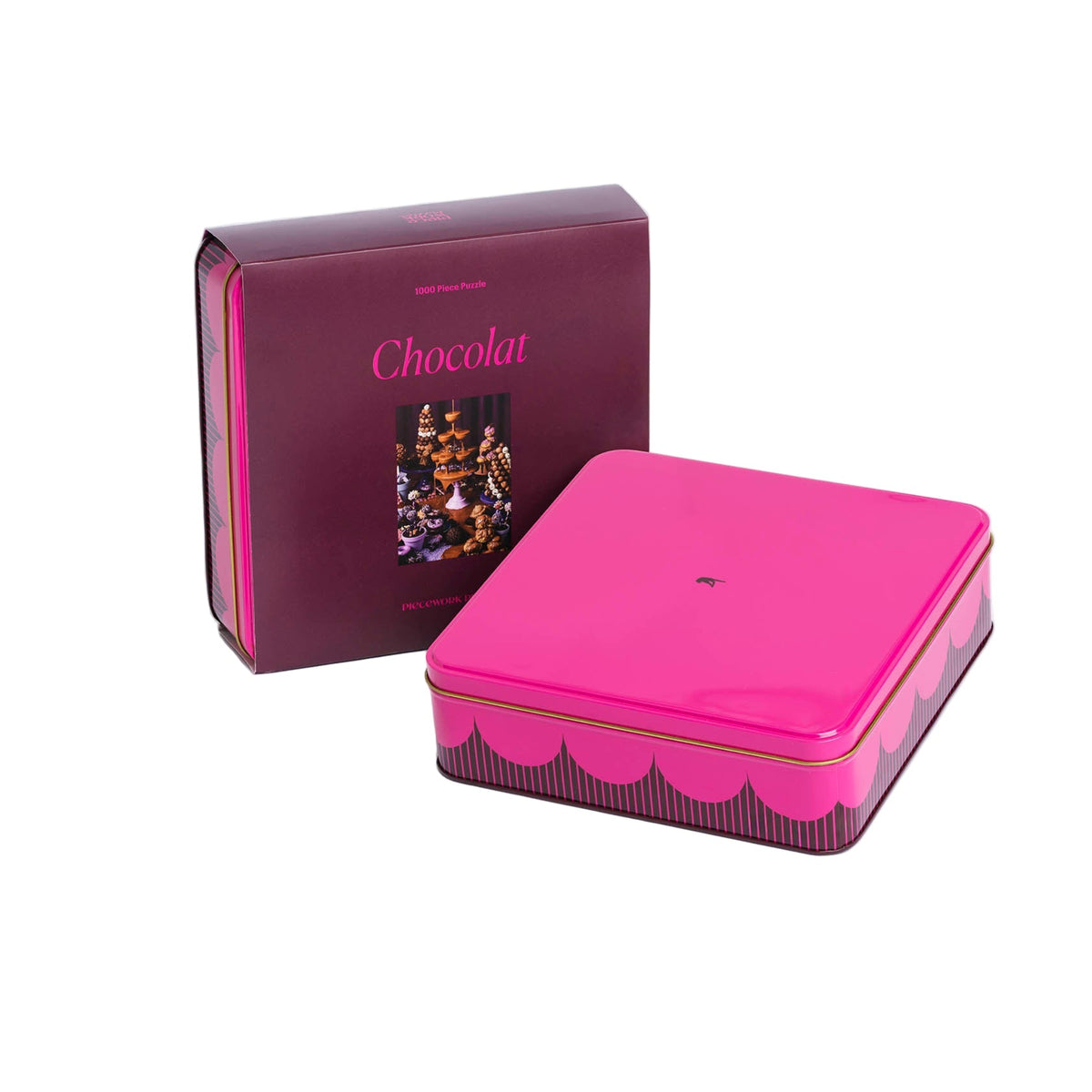 Pink chocolate tin containing puzzle pieces with 'Chocolat' branding on a white background