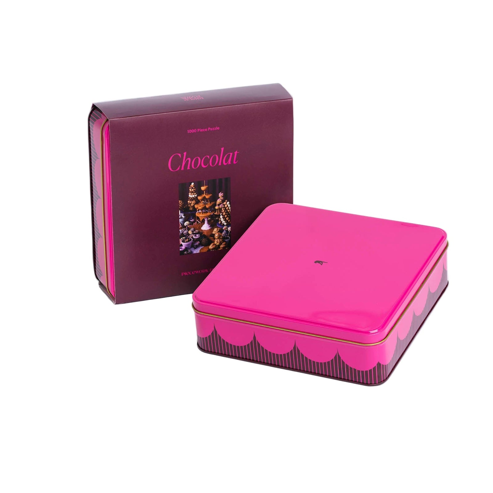 Pink chocolate tin containing puzzle pieces with 'Chocolat' branding on a white background