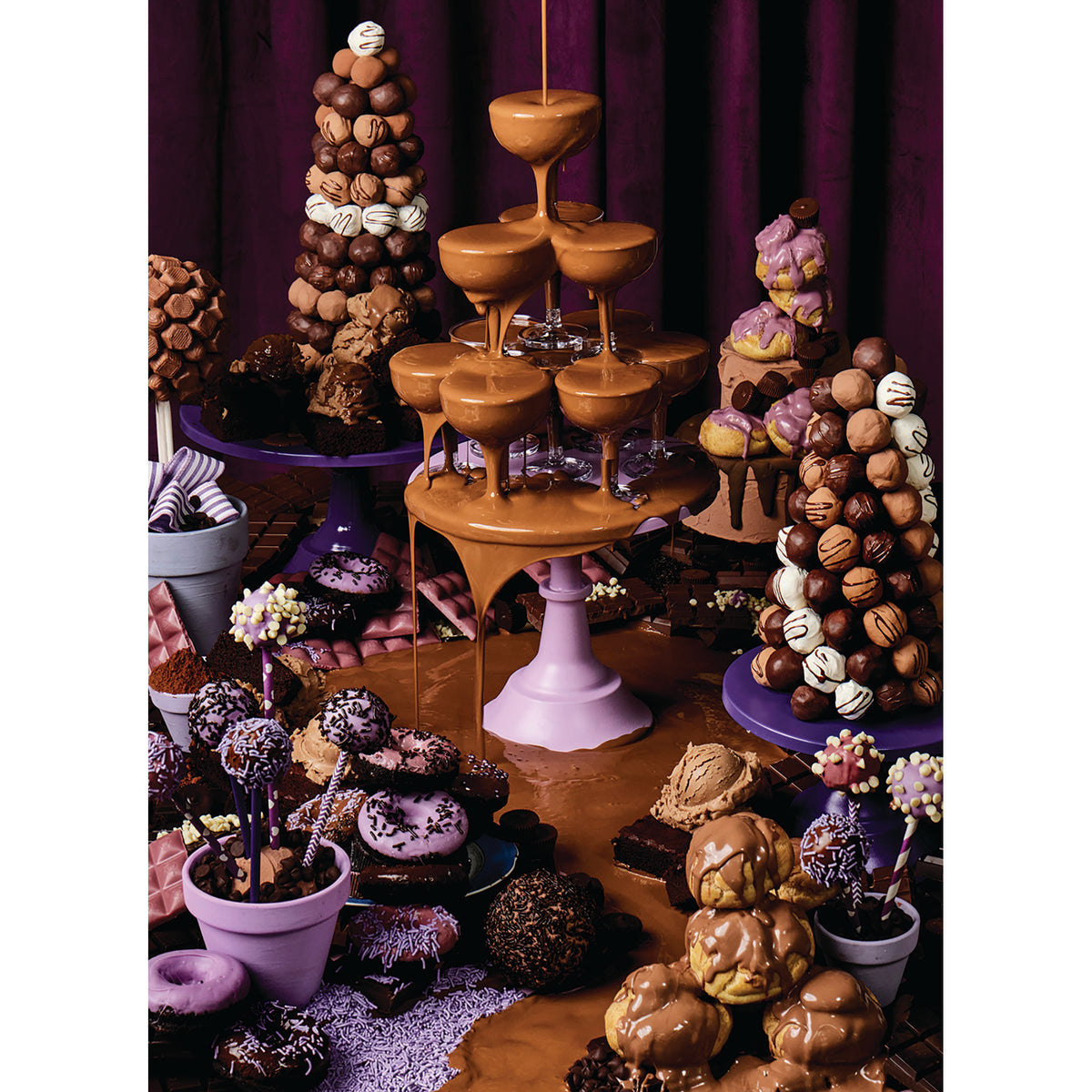 Dessert display with a chocolate fountain and various pastries against a dark background