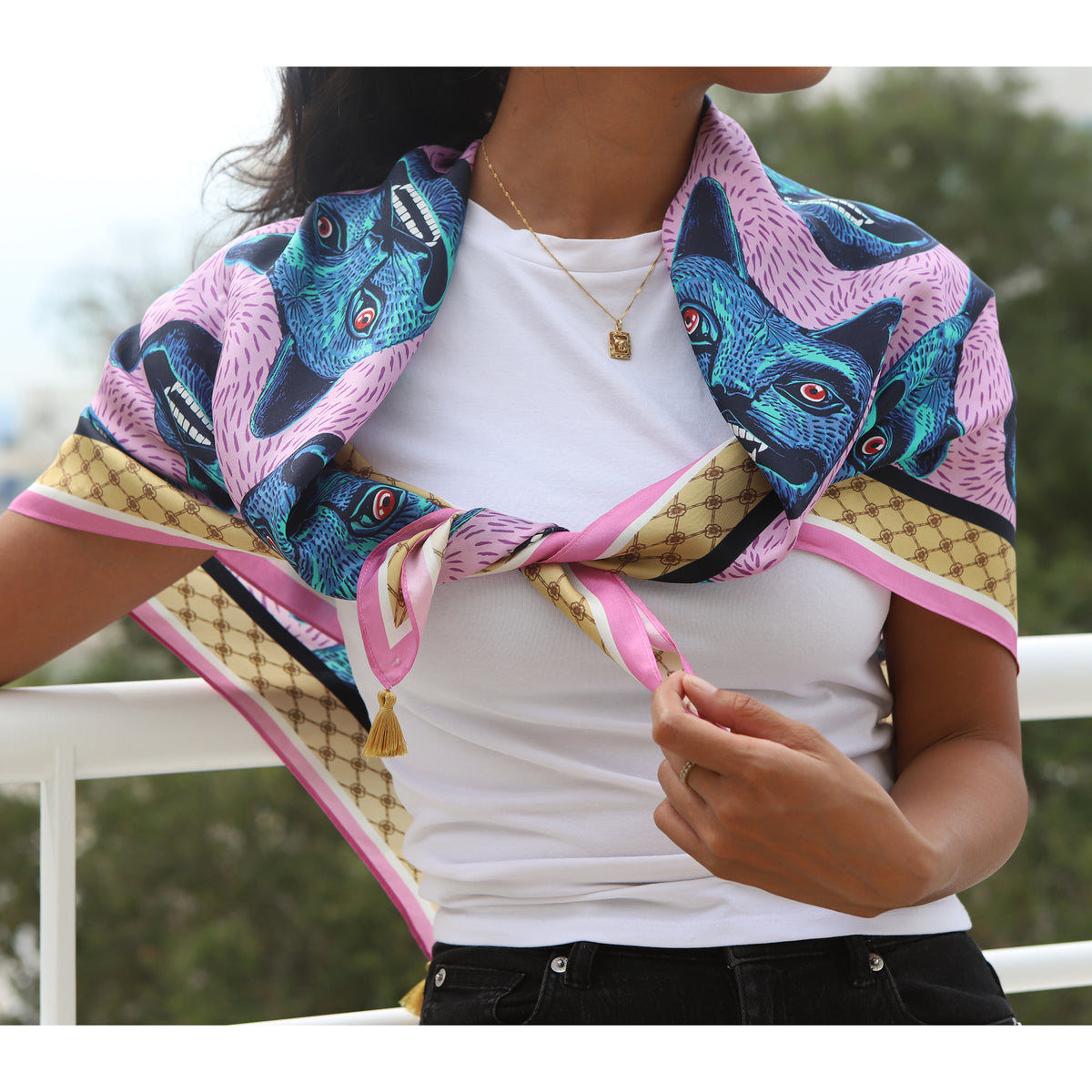 Person wearing a colorful scarf with animal design over a white shirt