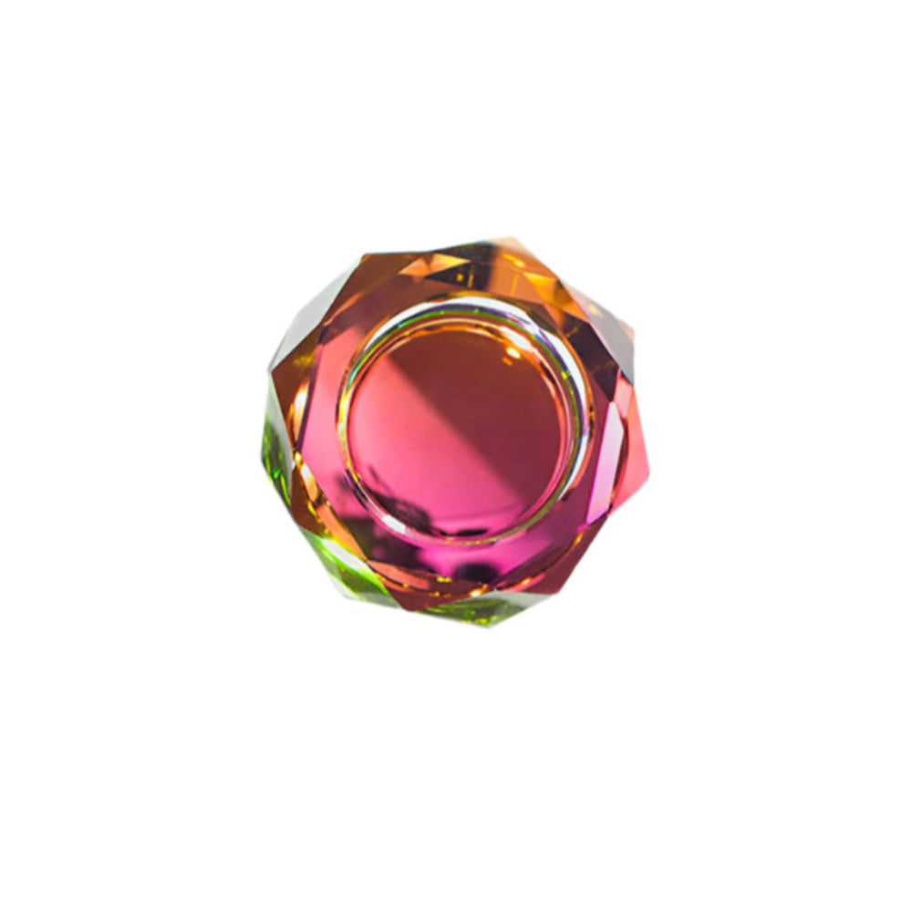 A hand cut crystal bowl with a multicolored reflective bottom, displaying a spectrum of colors when illuminated.