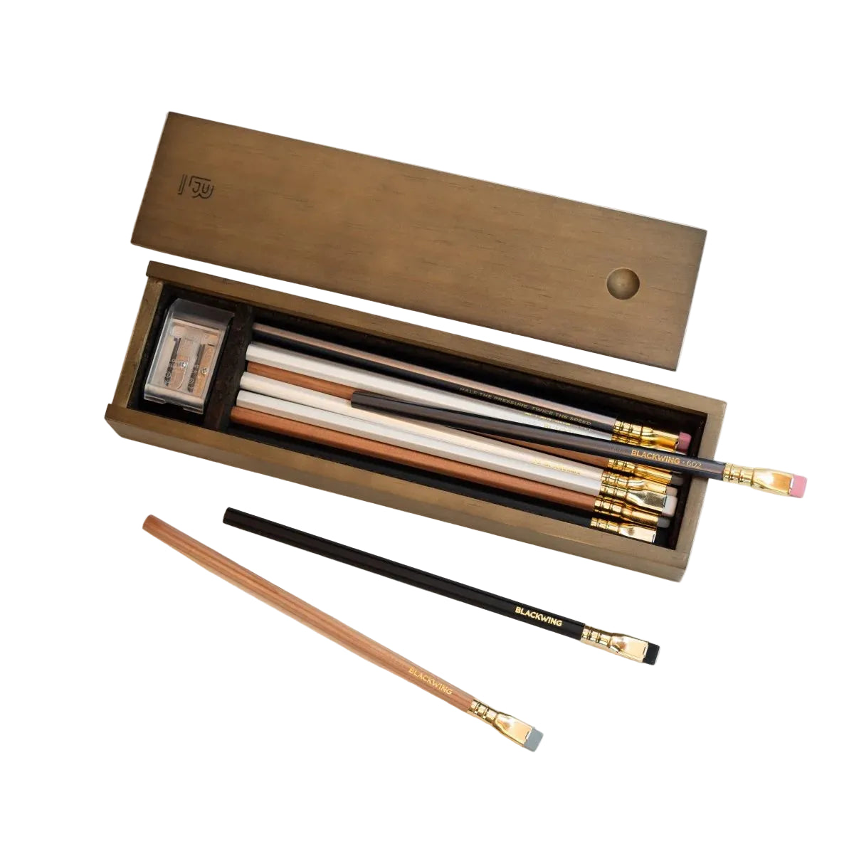 Set of pencils and an eraser in a wooden box on a white background