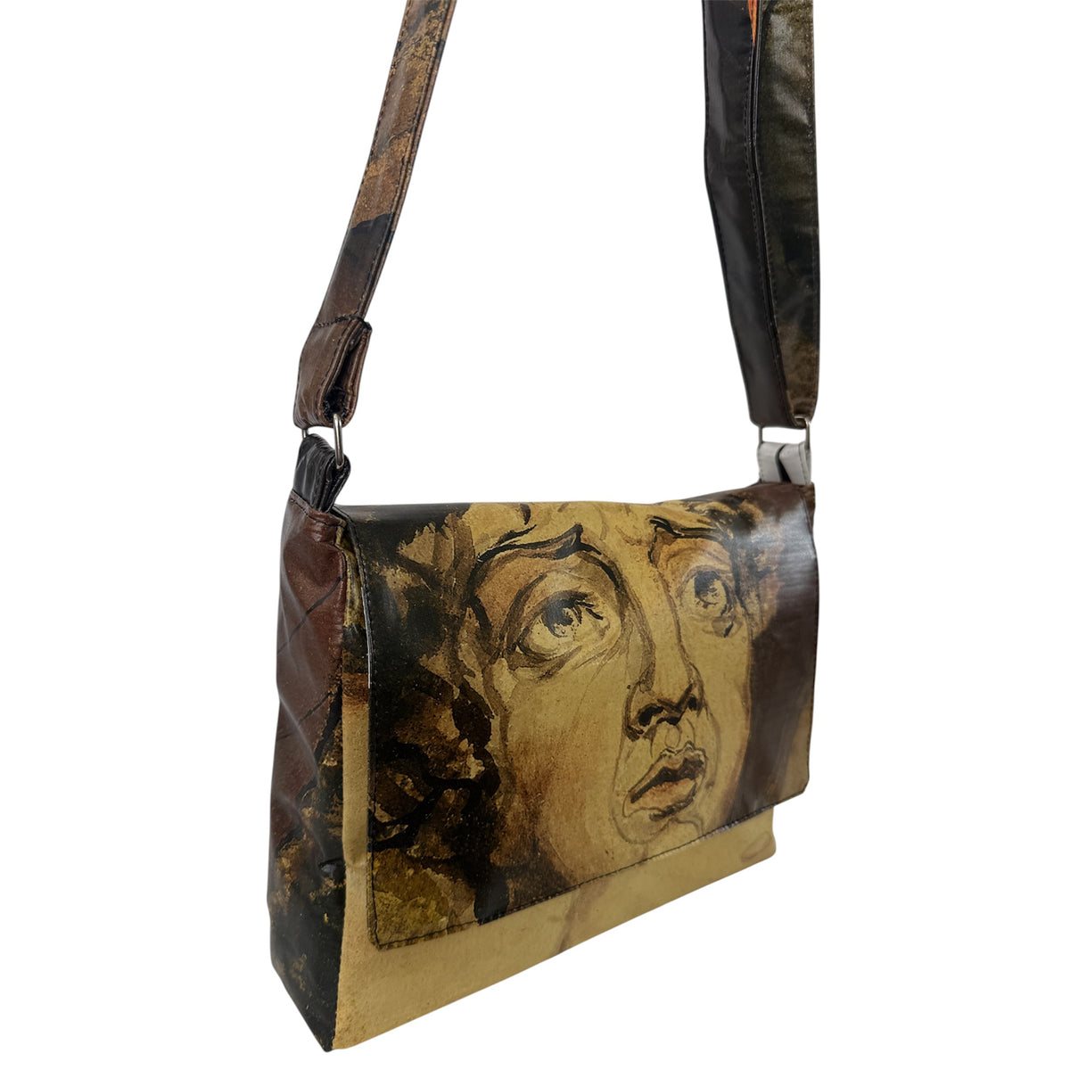 Handbag with artistic face design on a white background