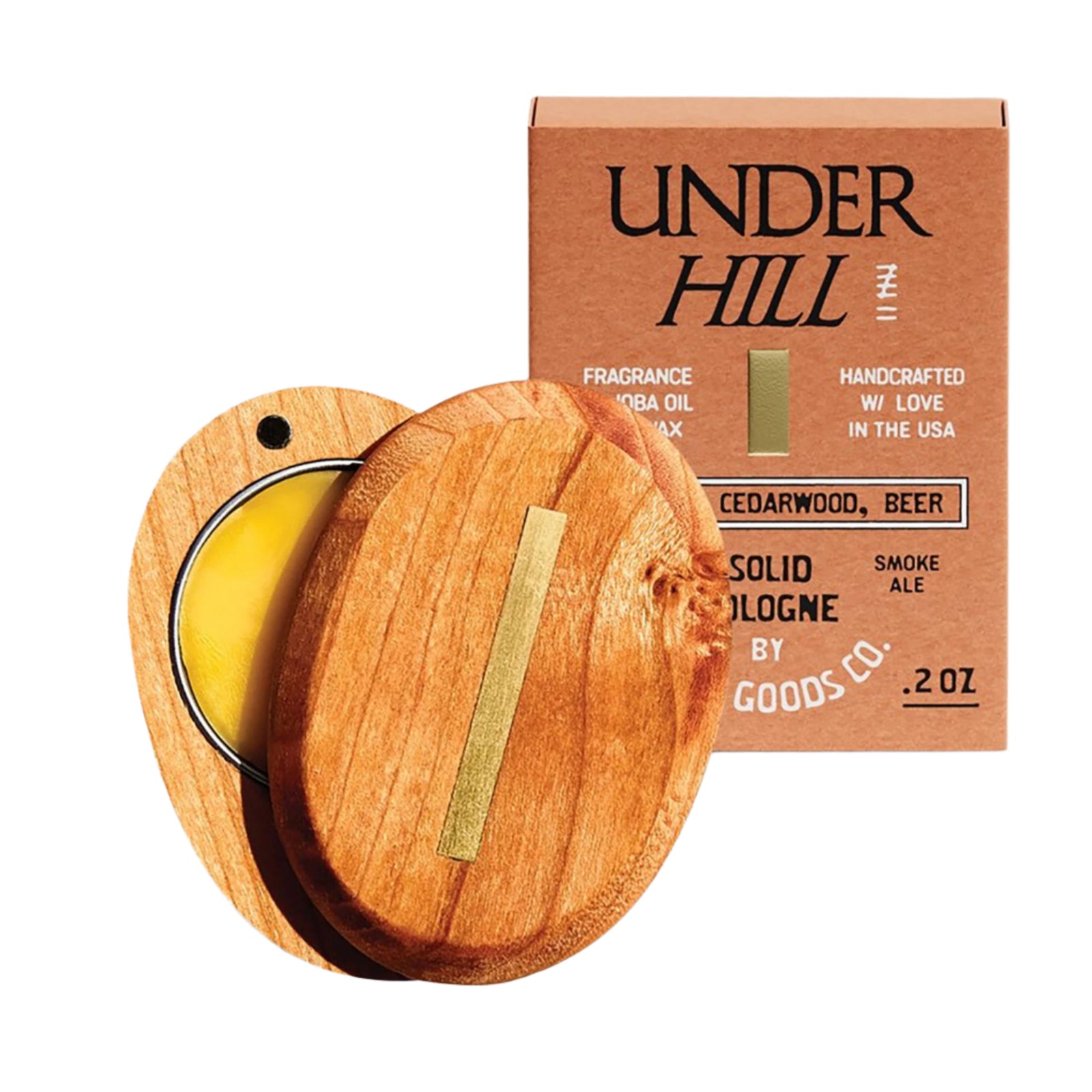 A solid cologne case with a wooden lid, labeled 'Underhill', next to its packaging box which has 'Smoke & Leather' indicated as the scent.