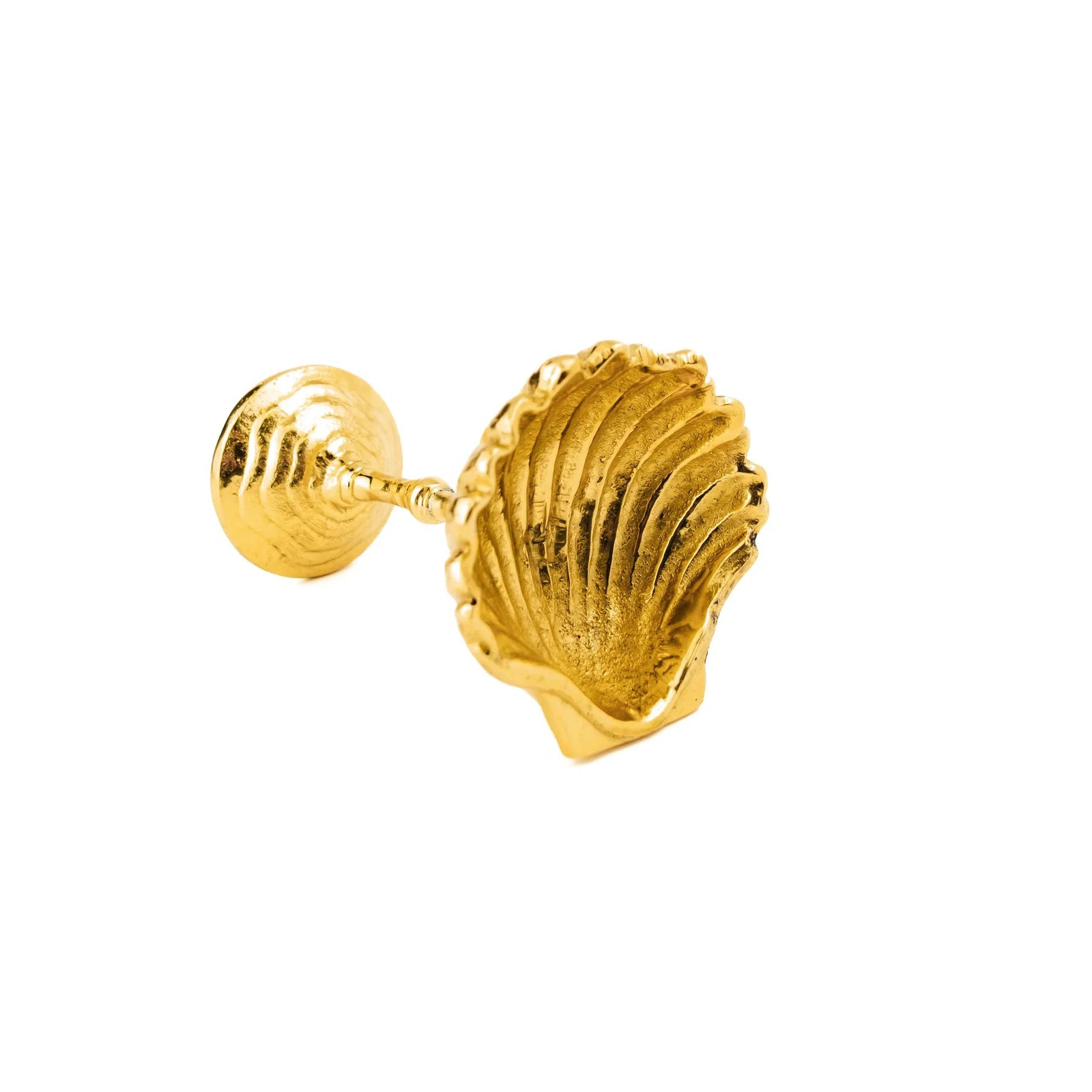 Gold shell-shaped dish on a white background
