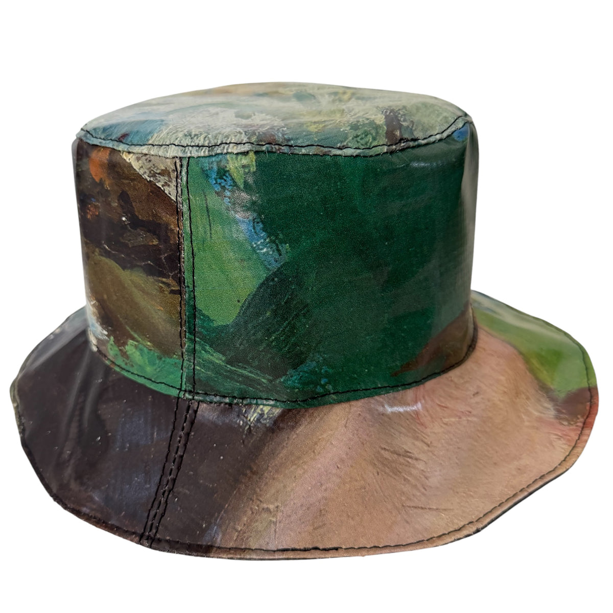 Bucket hat with a patchwork design in green, brown, and black on a white background