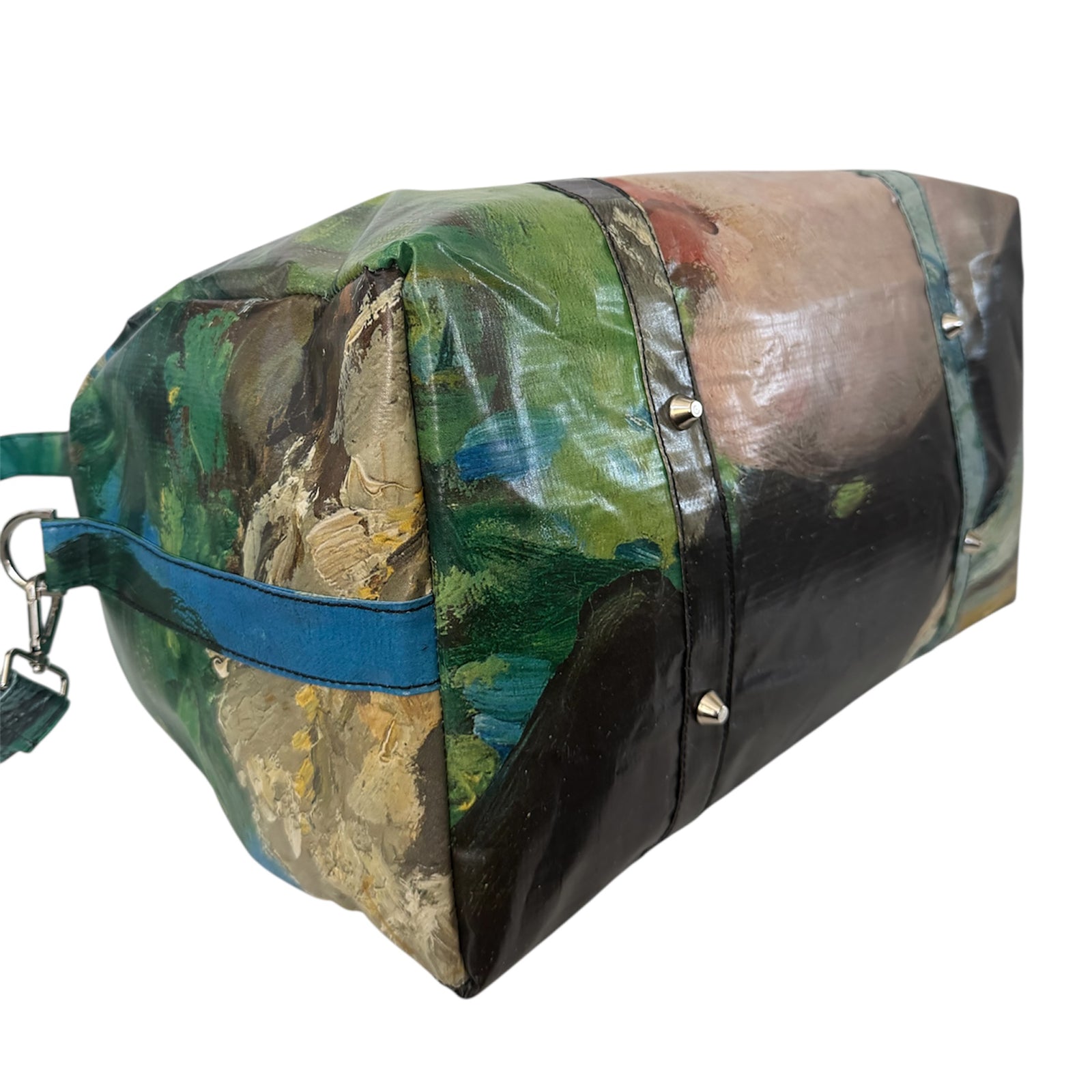 Duffle bag with artistic design of a face on a white background