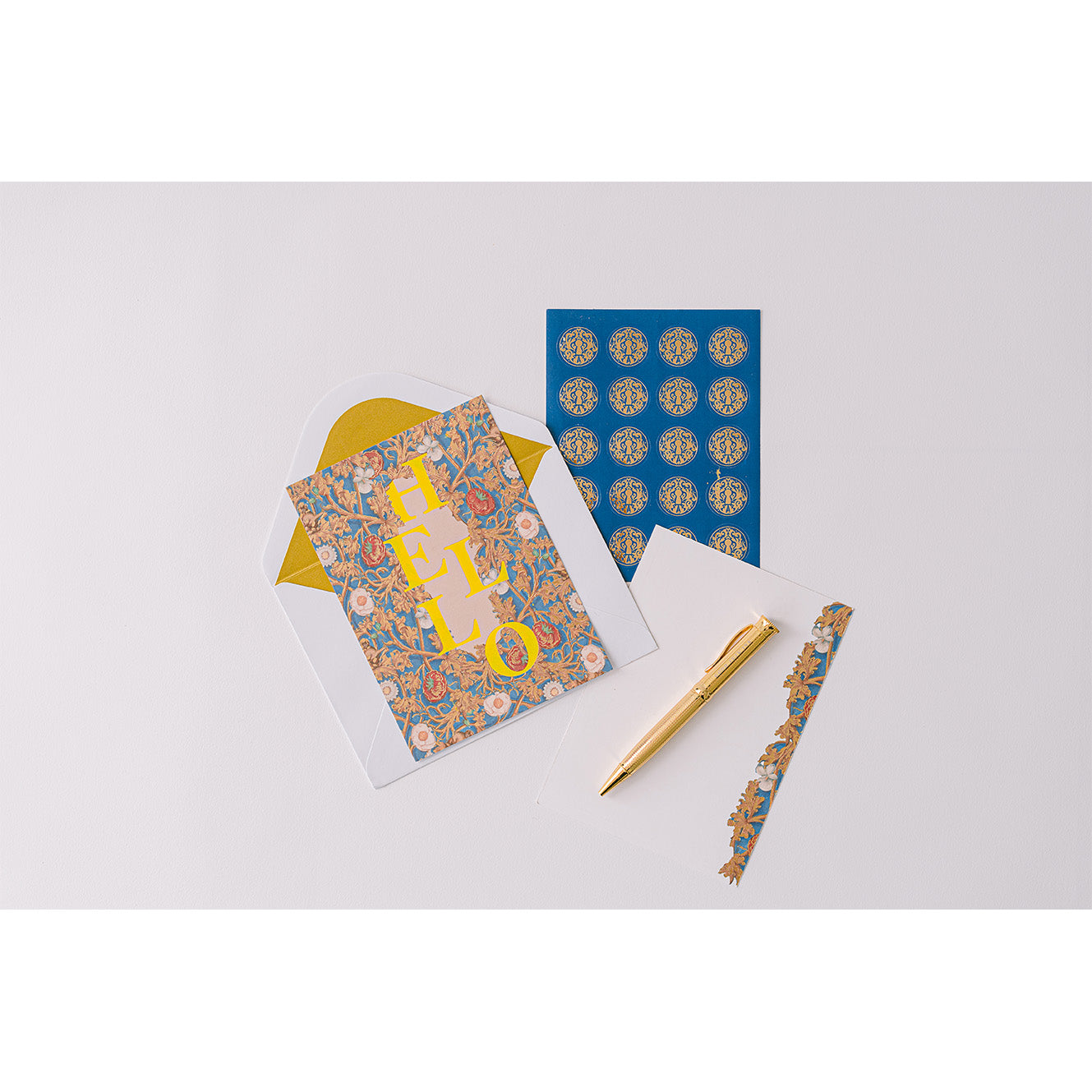 A luxury stationery set with blue illuminated designs, presented in a gold-foiled keepsake box with a magnetic flap closure.