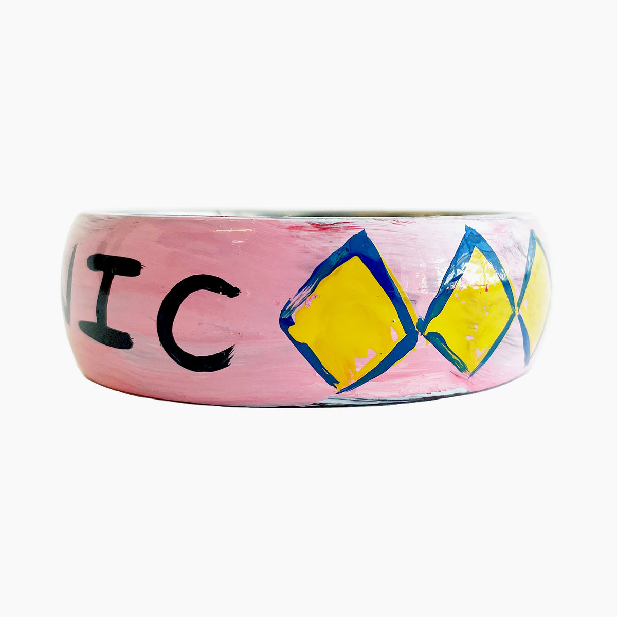 Pink bracelet with black text &#39;ICONIC&#39; and blue and yellow diamond patterns on a white background