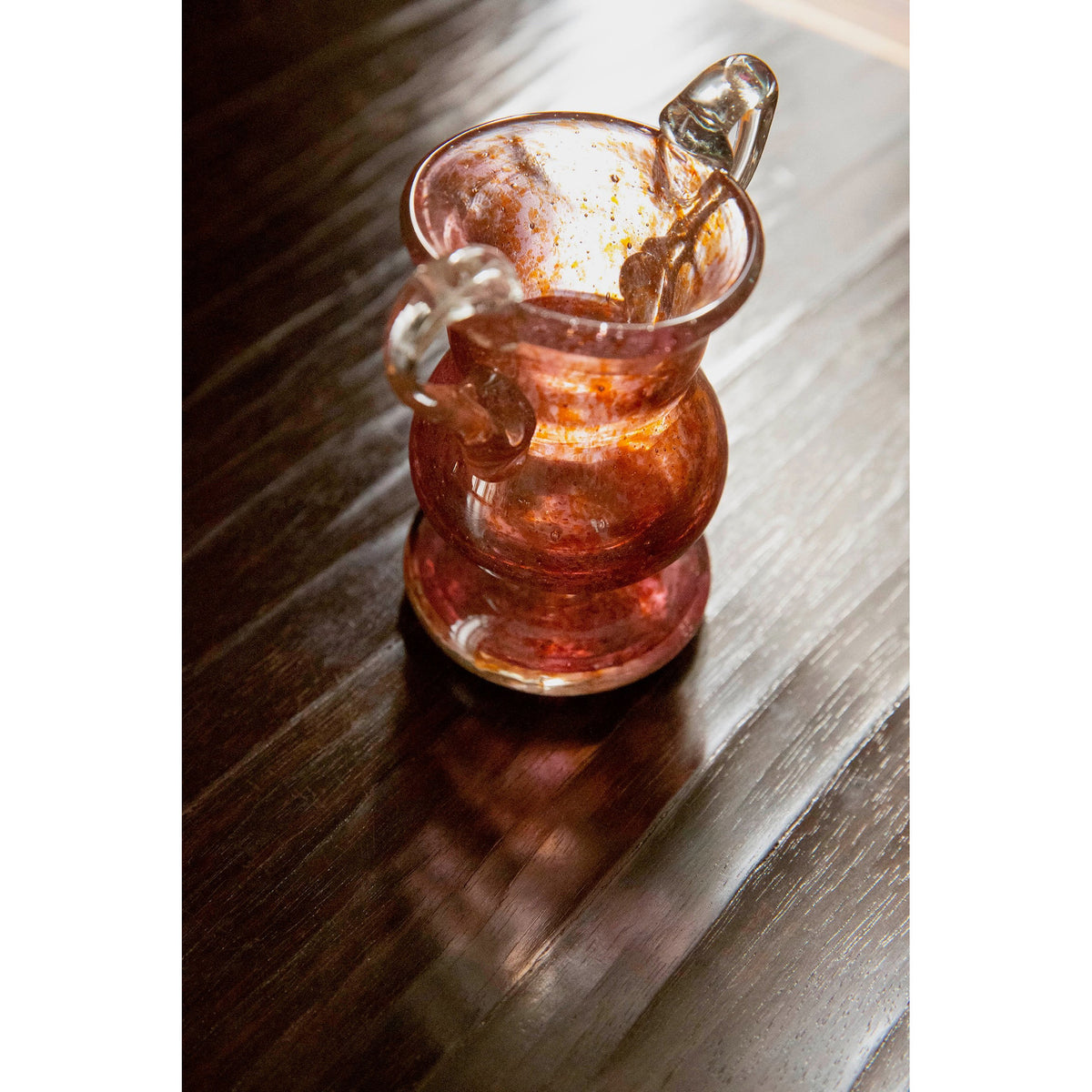 Rose glass vase on a wooden table