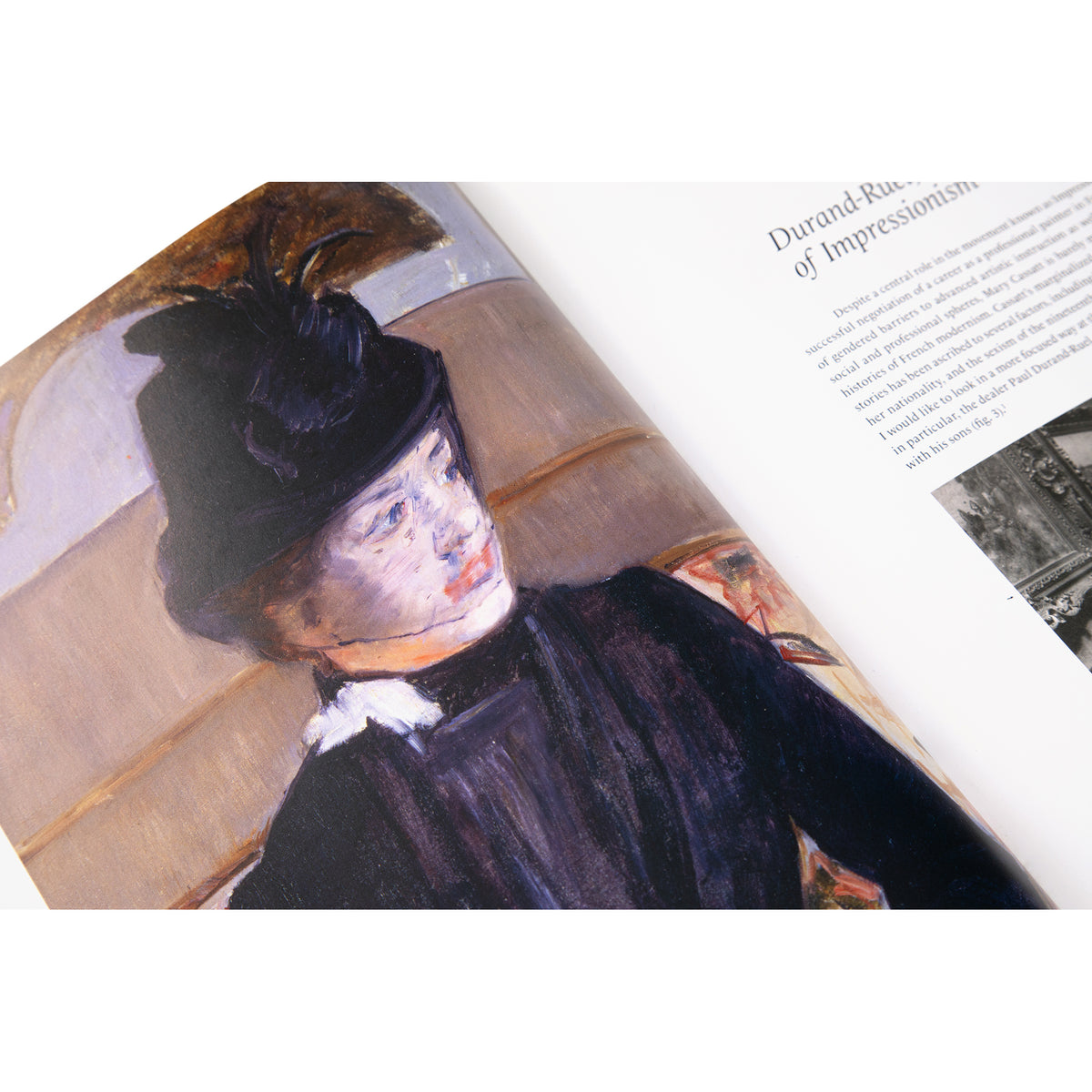 An open book showing a painted portrait of a woman in a dark hat and black dress on the left page and printed text on the right page, photographed against a white background.