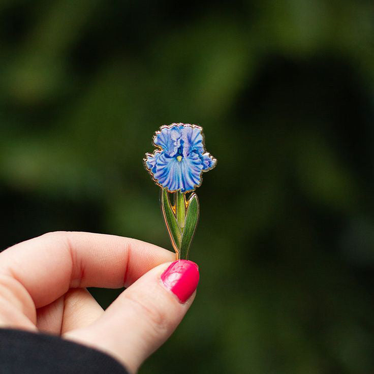 Blue flower-shaped pin on a white background