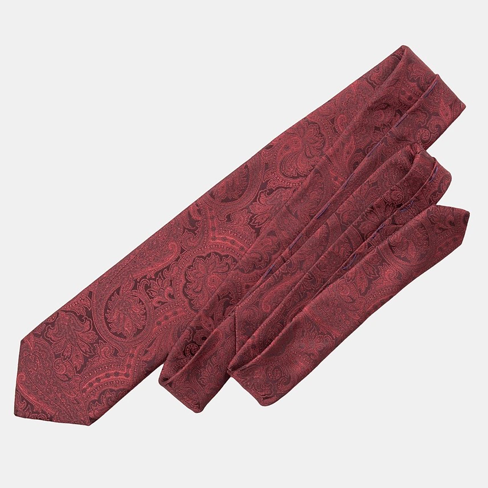 A folded silk jacquard tie in burgundy with an intricate woven paisley motif.