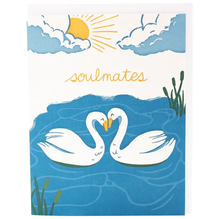 Card with two swans facing each other in water, sun and clouds above, and 'soulmates' text.