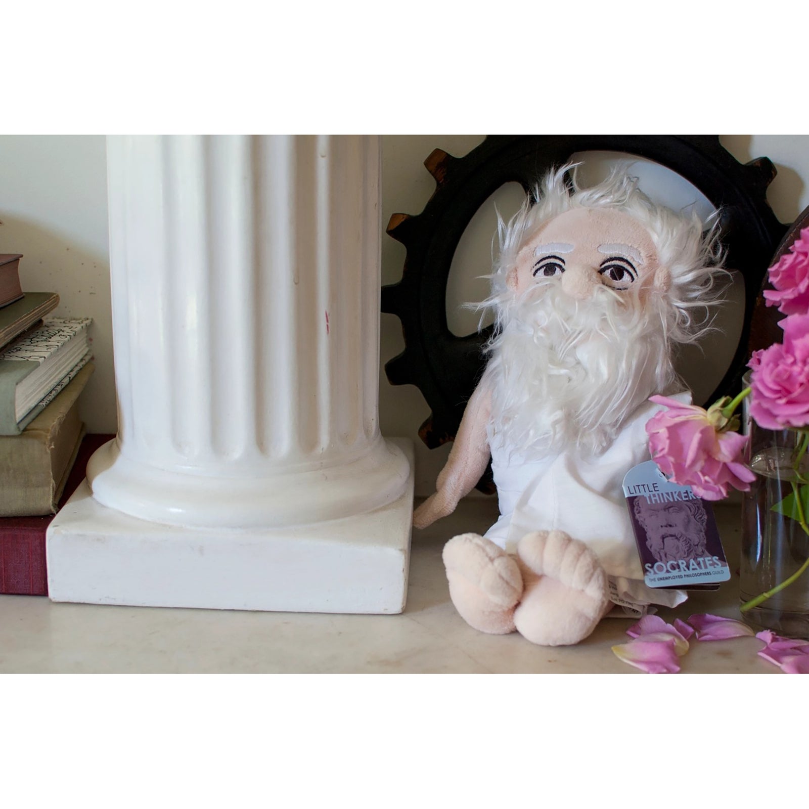 A plush doll of an elderly man with a long white beard, pinkish skin, and a light blue shirt, isolated on a white background.