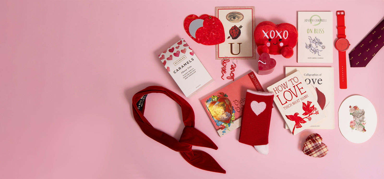 Collection of Valentine's Day cards and decorative items on a pink background