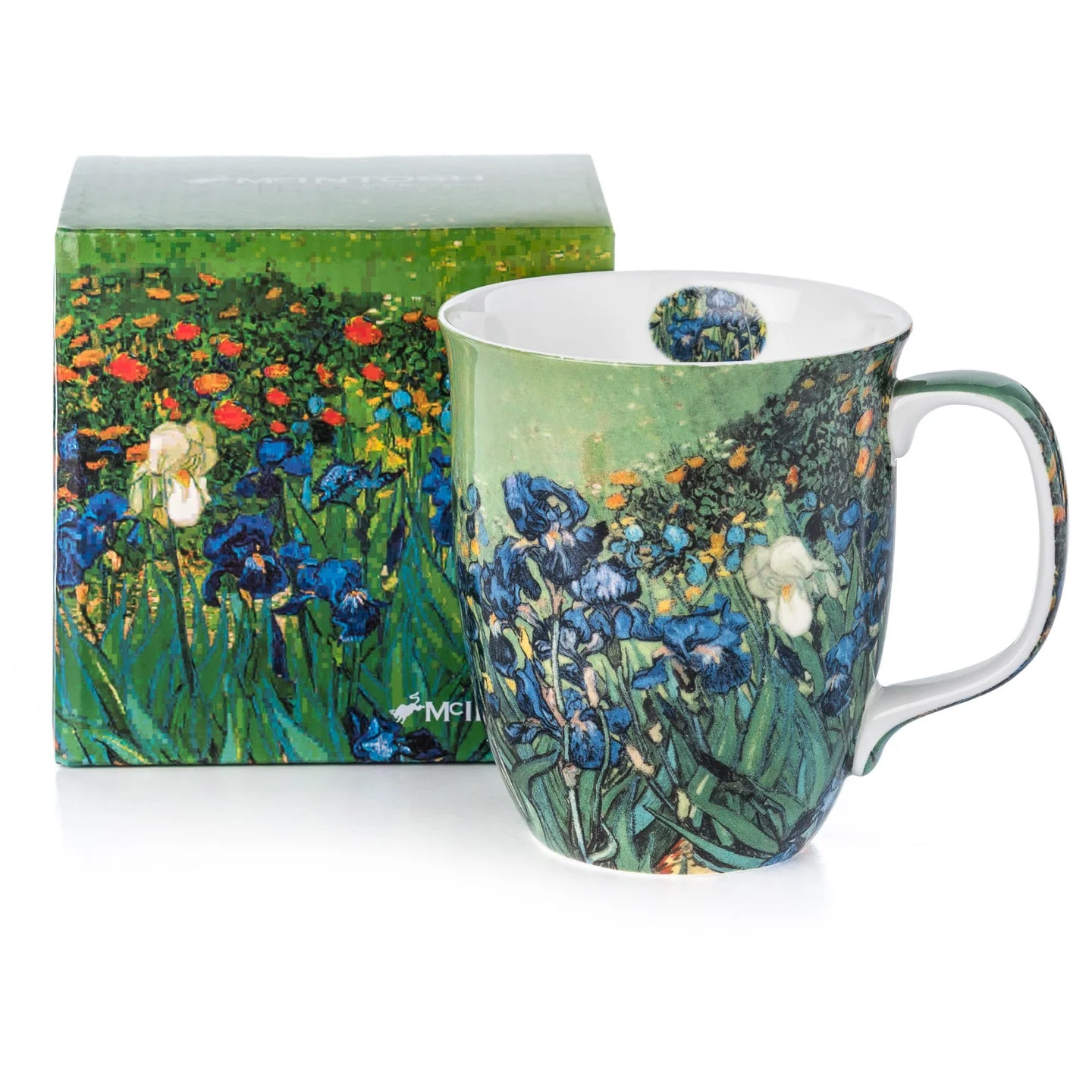 A ceramic mug featuring a detailed painting of blue irises and wildflowers on a white background, with a white interior and handle.