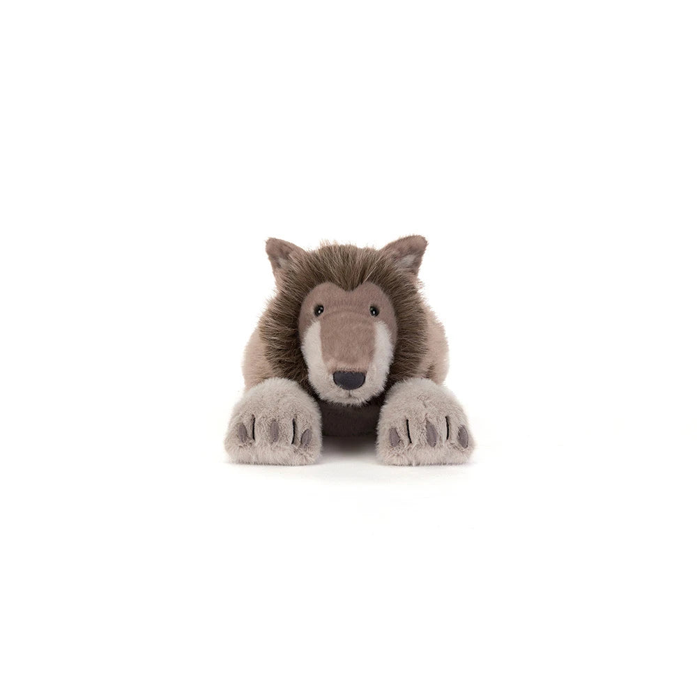 A plush stuffed animal of a brown and beige wolf, lying down with its front paws extended, photographed against a seamless white background.