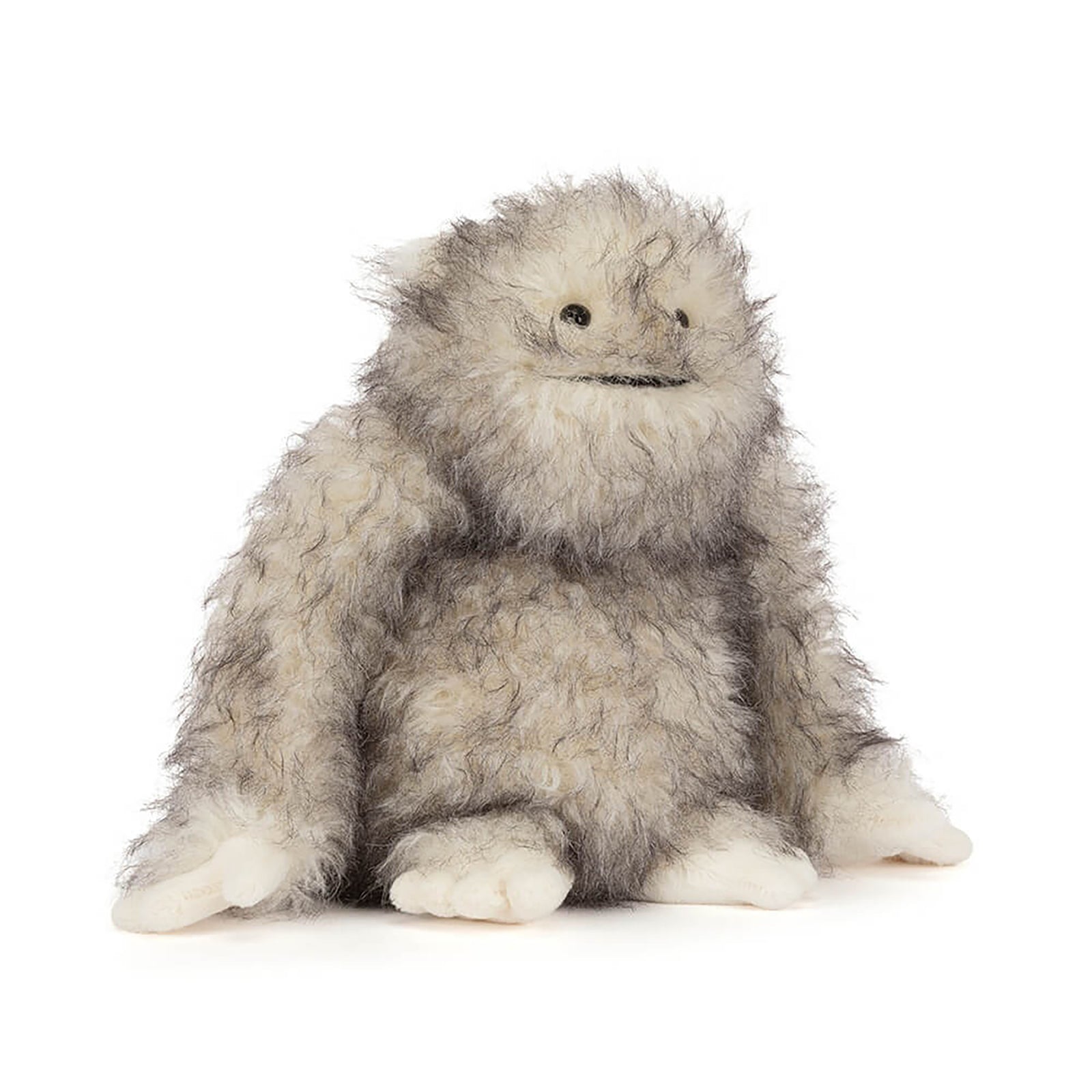 Plush toy resembling a fluffy creature on a white background