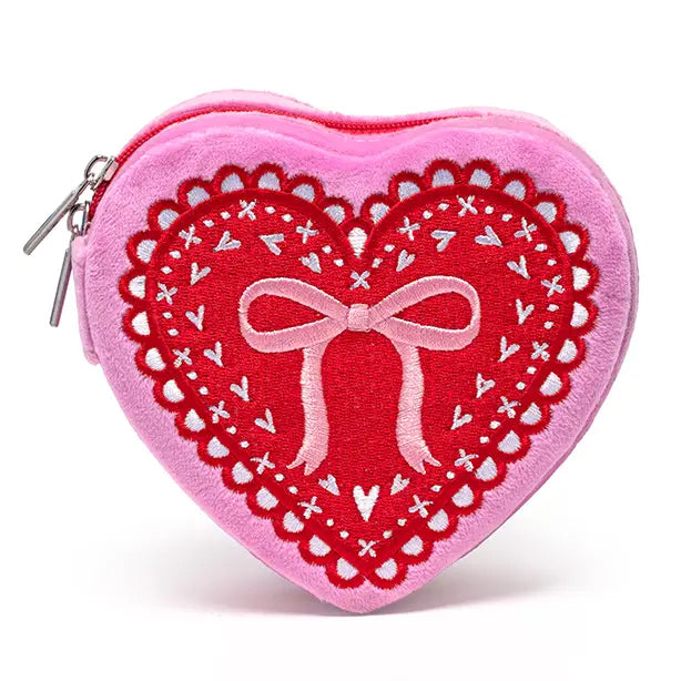 Heart-shaped pink pouch with red lace design and bow on a white background