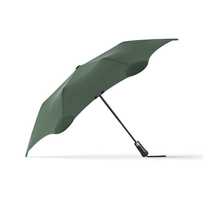 A dark green folding umbrella shown open against a clean white background, with a black handle and shaft.