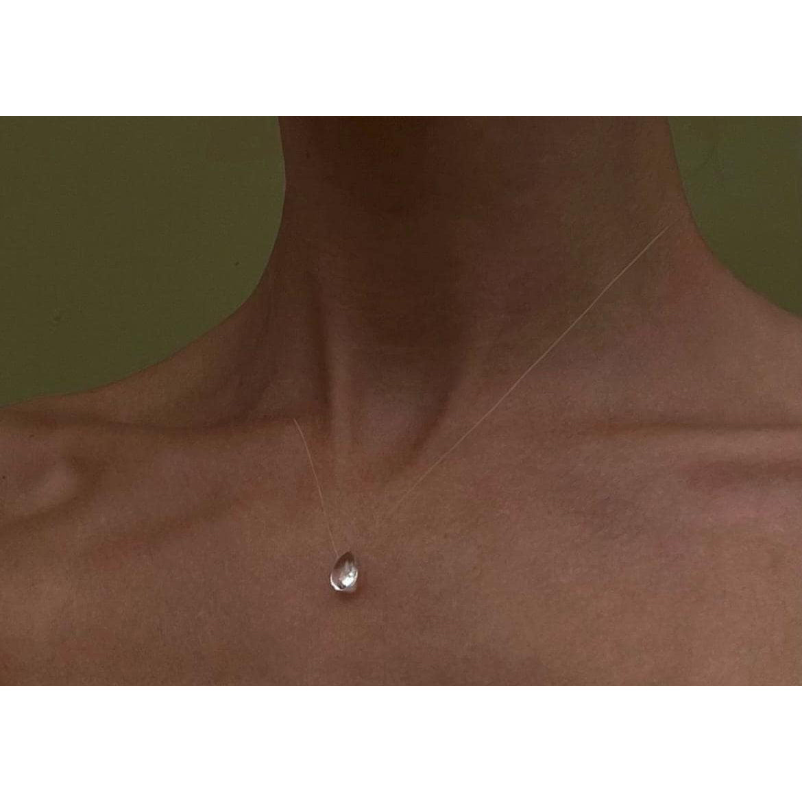 Teardrop-shaped crystal necklace on a white background