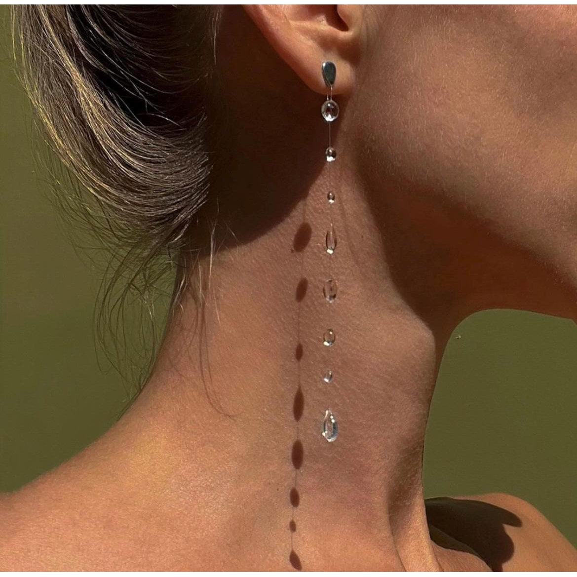 Set of glass teardrop shaped earrings on a white background