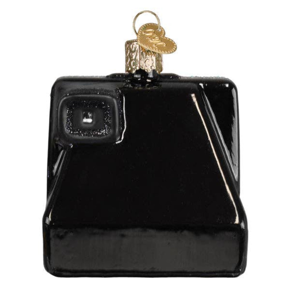 A glossy black camera-shaped ornament with a gold hanging loop and a small textured gold emblem near the top, shown on a plain white background.