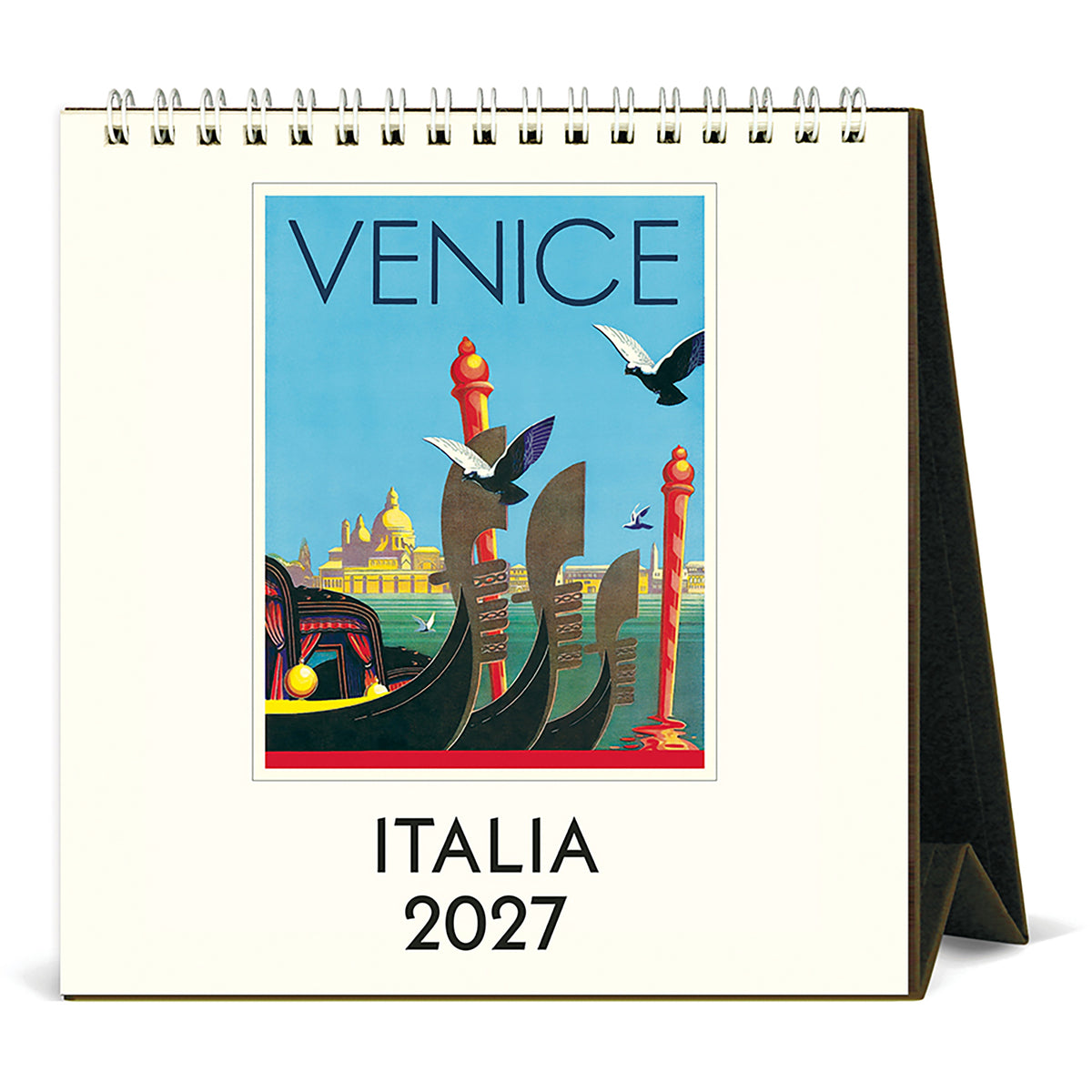 A spiral-bound desk calendar showing a vintage-style Venice travel poster on the front cover, with the text 'VENICE' and 'ITALIA 2027' below the artwork. The calendar is photographed standing upright on a black display stand against a plain white background.