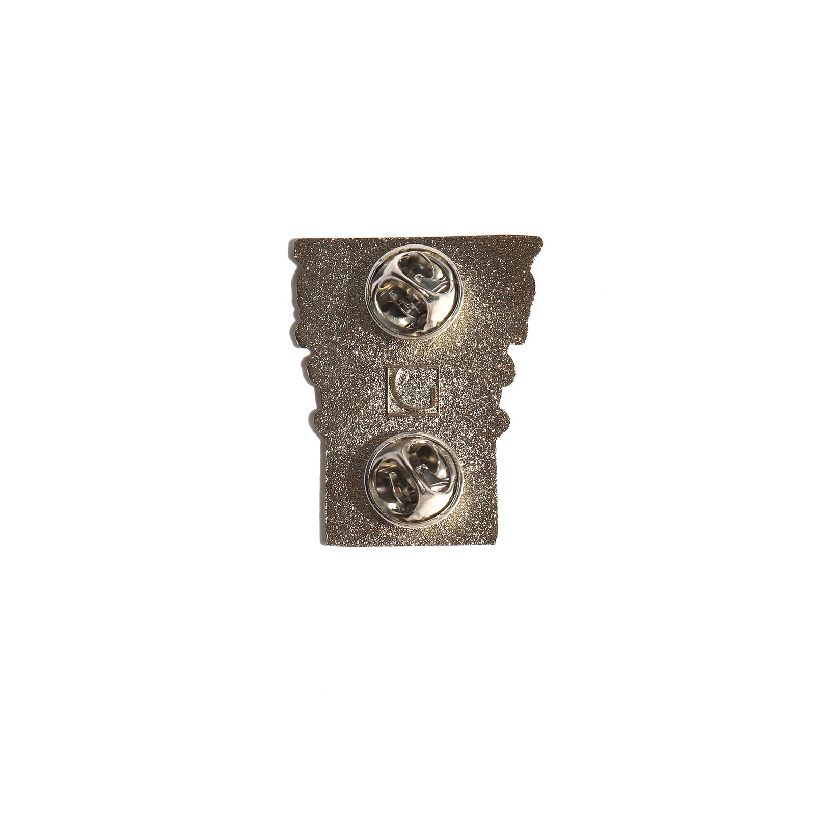 Decorative metal pin with intricate design on a white background
