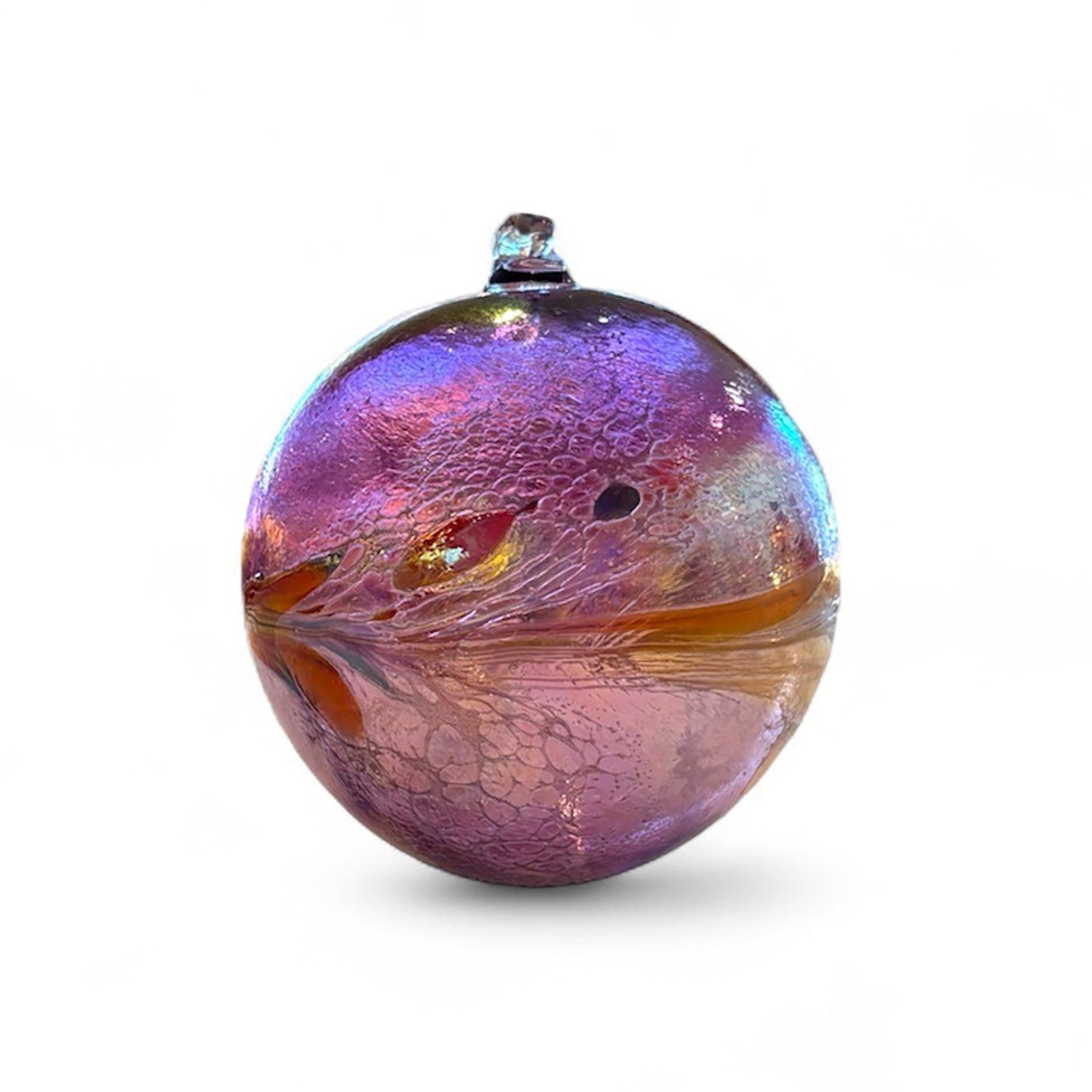 Multicolored purple toned glass ornament on a white background