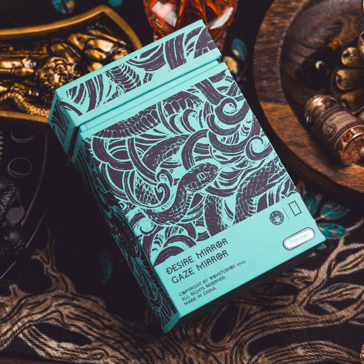 Teal packaging with intricate patterns on a textured surface