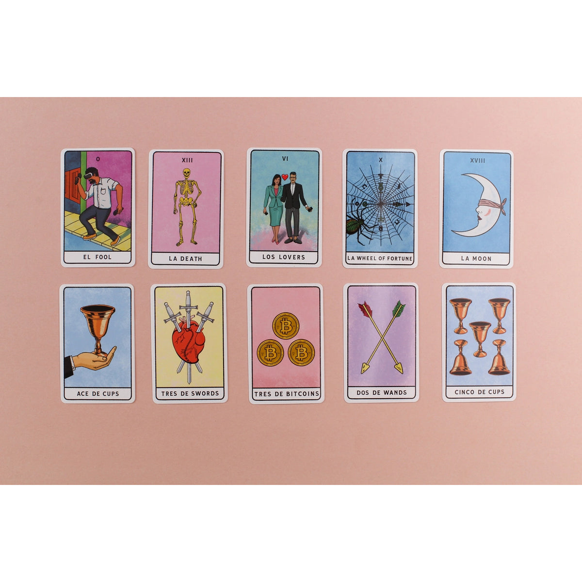 A set of ten tarot-style cards arranged in two rows on a solid pink background. The cards feature pastel colors and classic suit illustrations including cups, swords, coins, and a wheel of fortune, with Spanish titles at the bottom of each card.